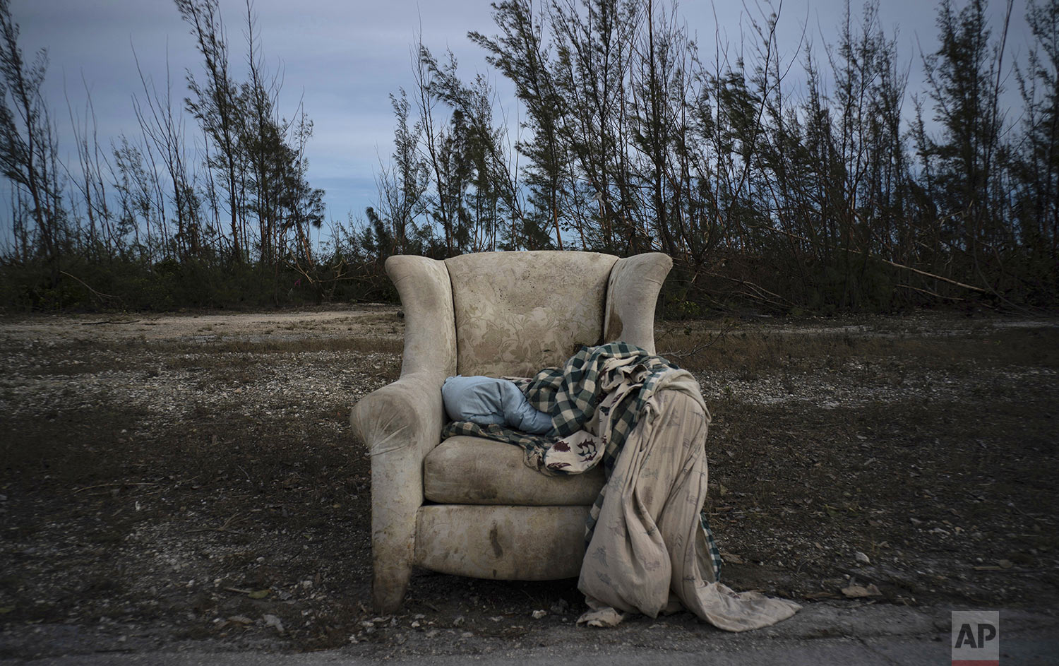 The lounger in which Virginia Mosvold was rescued from her home in Ol' Freetown Farm, flooded by rains brought on by Hurricane Dorian, lays abandoned on the side of a road on the outskirts of Freeport, Bahamas, Wednesday, Sept. 4, 2019. (AP Photo/Ramon Espinosa)