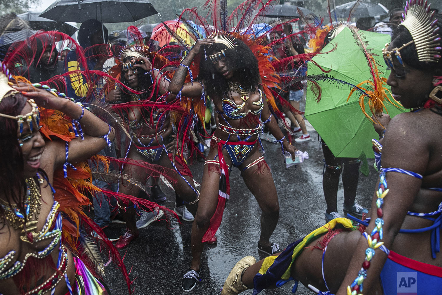 Revelers participate in the West Indian American Day Parade in the Brooklyn borough of New York, Monday, Sept. 2, 2019 (AP Photo/Jeenah Moon)