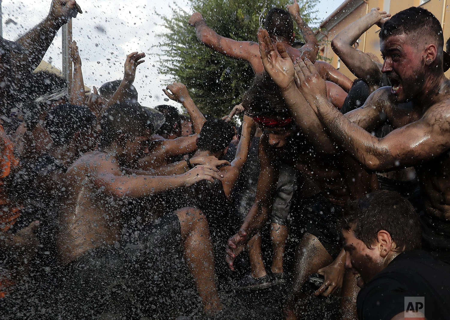 People painted with black grease celebrate during the traditional festivities of the Cascamorras festival in Baza, Spain, Friday, Sept. 6, 2019. (AP Photo/Manu Fernandez)