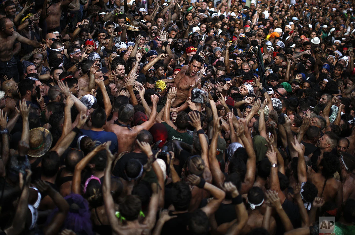 People painted with black grease celebrate during the traditional festivities of the Cascamorras festival in Baza, Spain, Friday, Sept. 6, 2019. (AP Photo/Manu Fernandez)