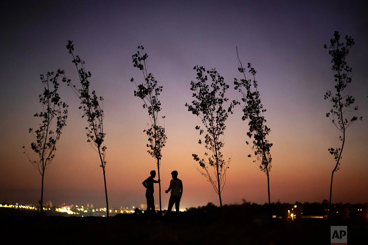 Boys stand atop a hill where a bonfire is lit in celebration of Ashura, in Sale, near Rabat, Morocco, Sept. 9, 2019. (AP Photo/Mosa'ab Elshamy)