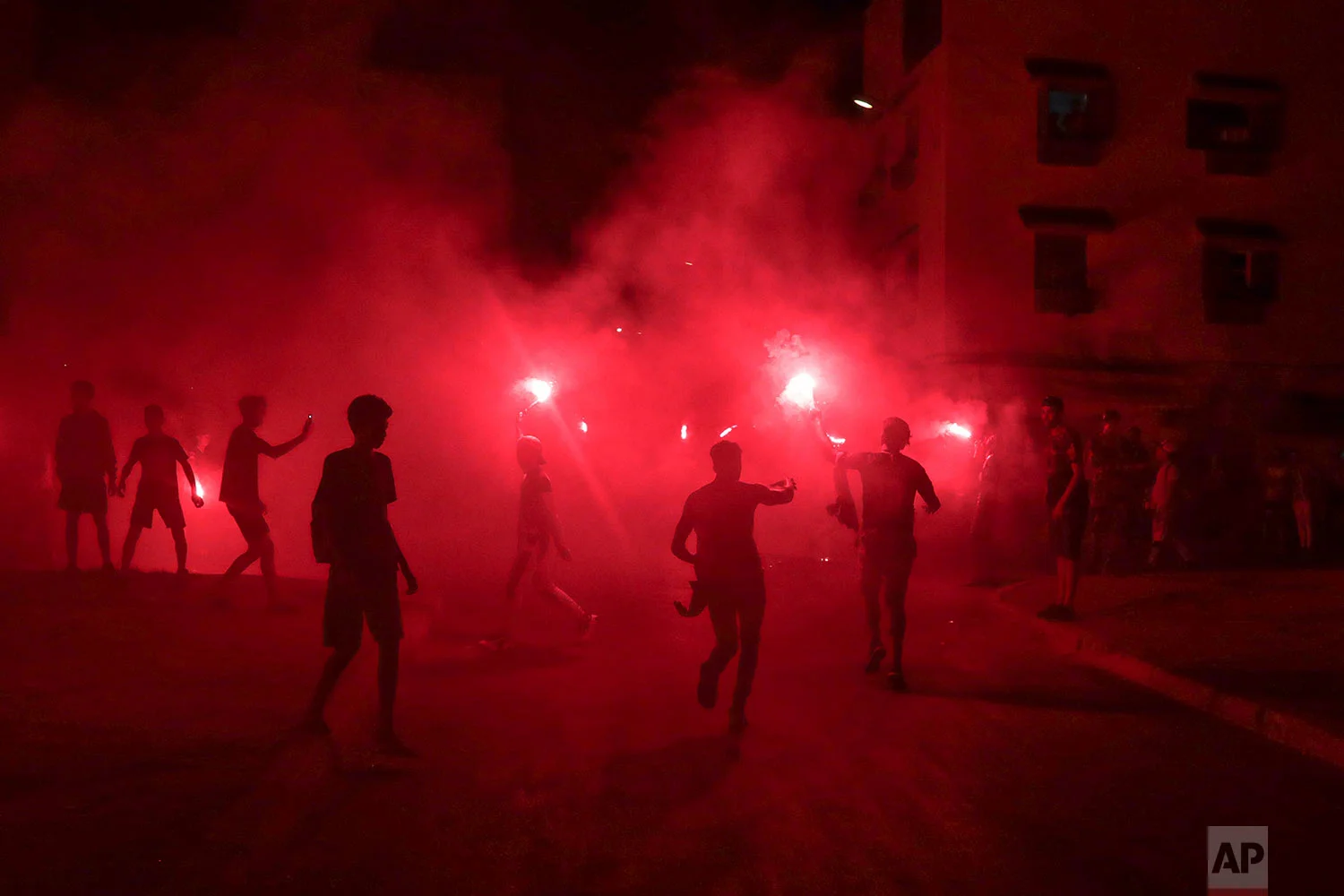 Youths, mostly football ultras, light flares in celebration of Ashura, in Sale, near Rabat, Morocco, Sept. 9, 2019. (AP Photo/Mosa'ab Elshamy)