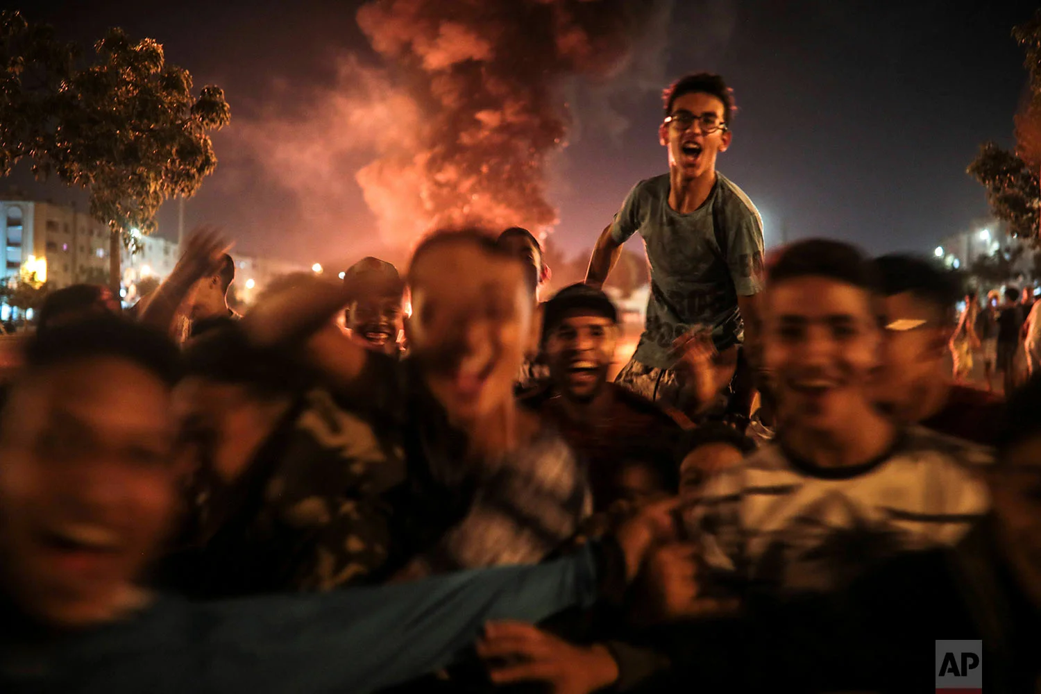 Youths react during the celebration of Ashura, in Sale, near Rabat, Morocco, Sept. 9, 2019. (AP Photo/Mosa'ab Elshamy)