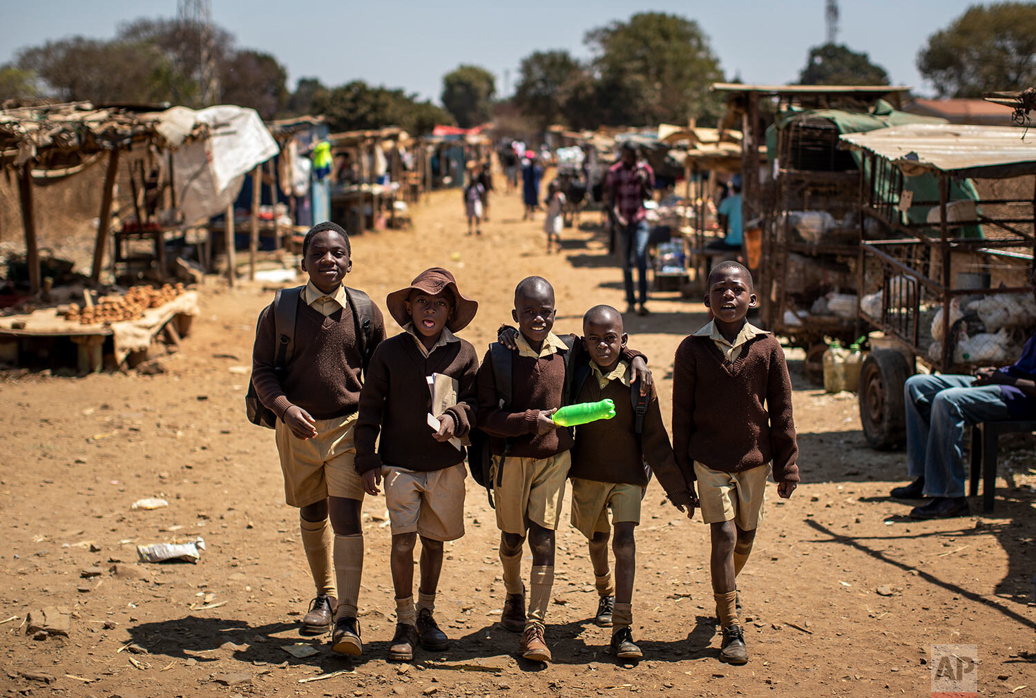 Schoolboys walk back home on the first day of the school term, in Kuwadzana, on the outskirts of the capital Harare, in Zimbabwe, Sept. 10, 2019. (AP Photo/Ben Curtis)