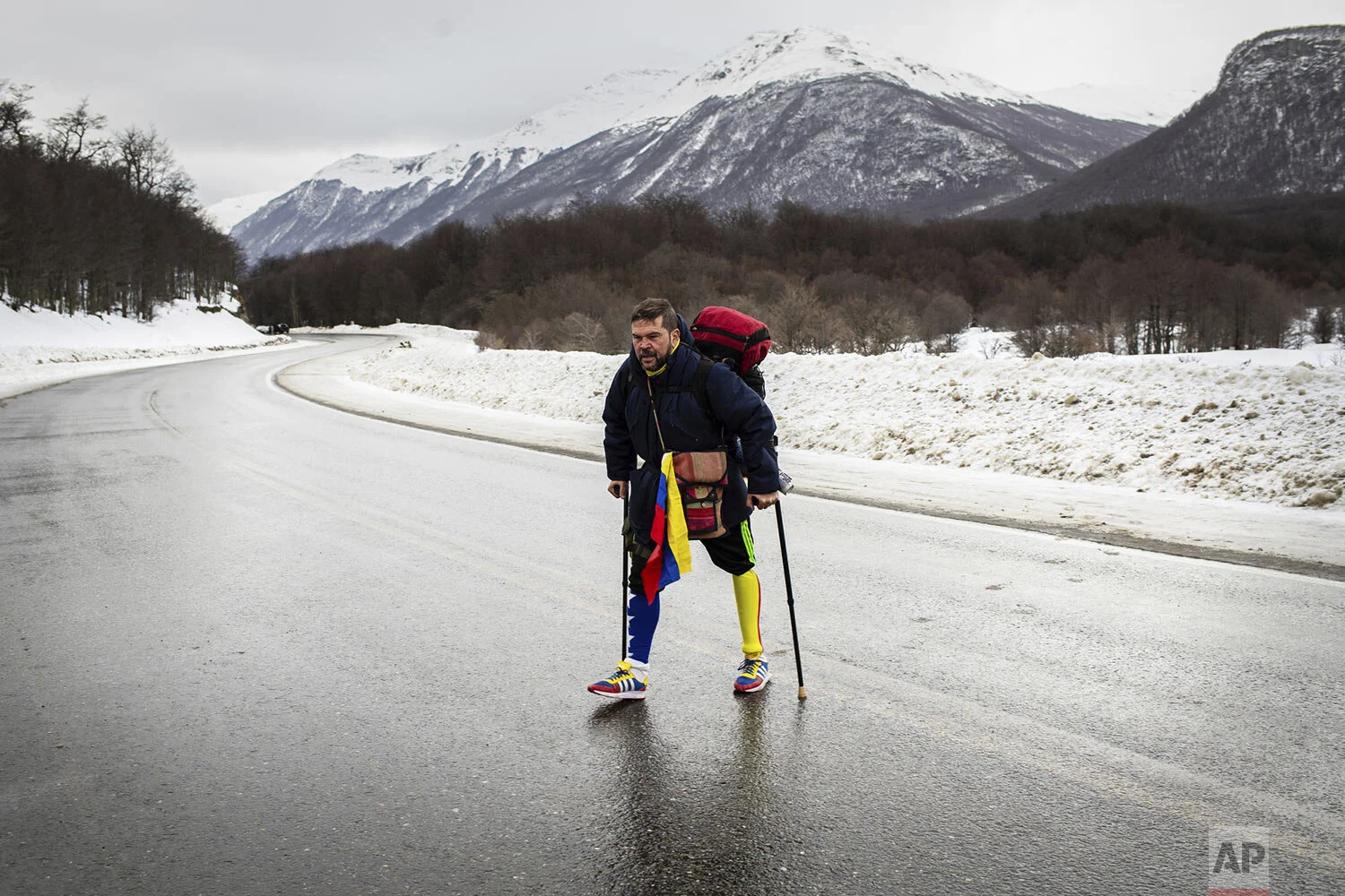 Venezuelan Yeslie Aranda, 57, walks on Route 3 between Tolhuin and Ushuaia, Argentina, Aug. 17, 2019. Aranda left his hometown of San Cristobal in the southeastern state of Táchira last year with a backpack, $30 in his pocket and an aluminum prosthesis that enabled him to negotiate the continent’s rugged roads. (AP Photo/Luján Agusti)