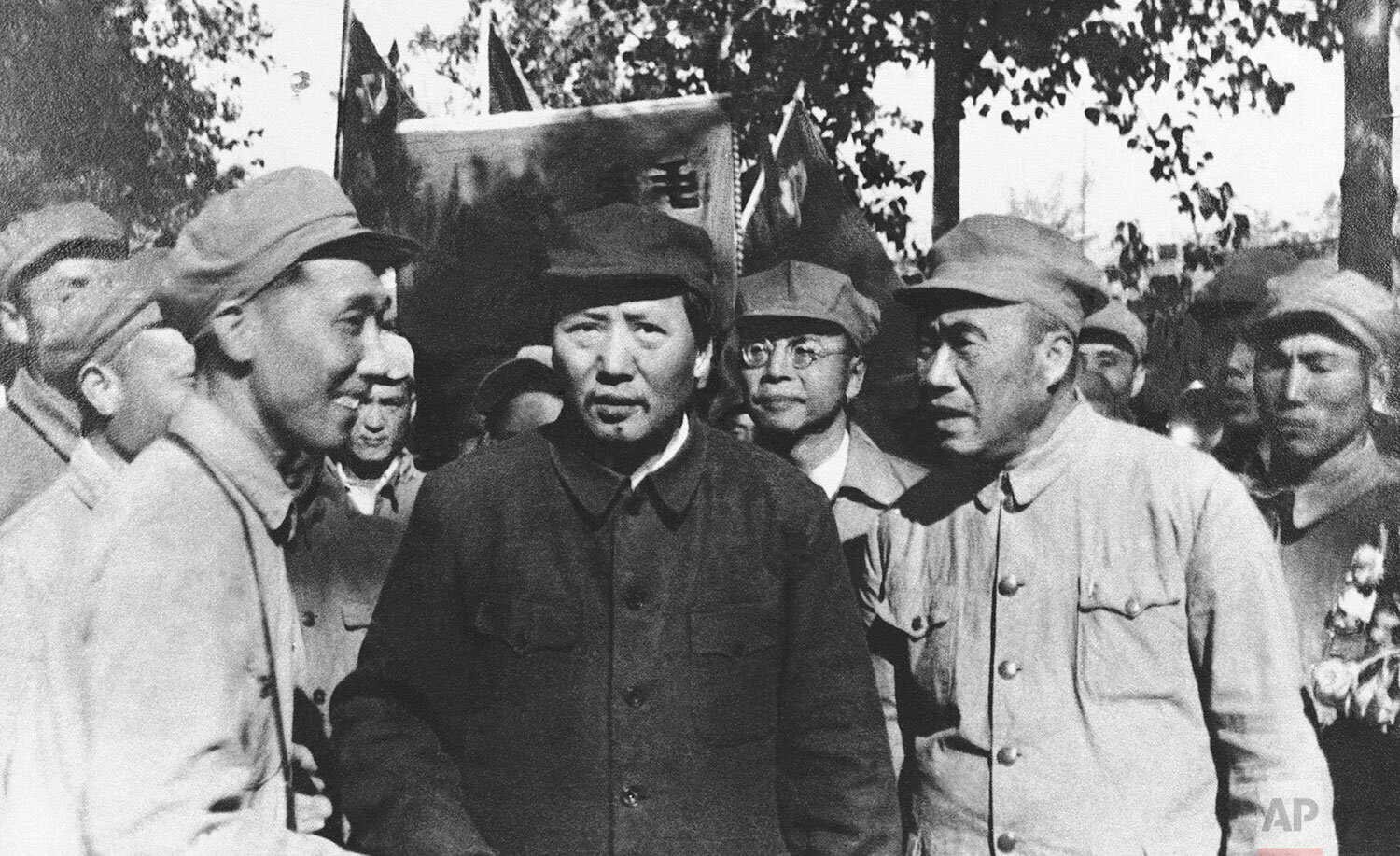  On a tour of Peiping, which he has selected as the capital of Red China, communist chief Mao Zedong (center, dark coat), greets a group of Communist army commanders, Gen. Chu Teh in Peiping, China, Sept. 18, 1949. (AP Photo) 