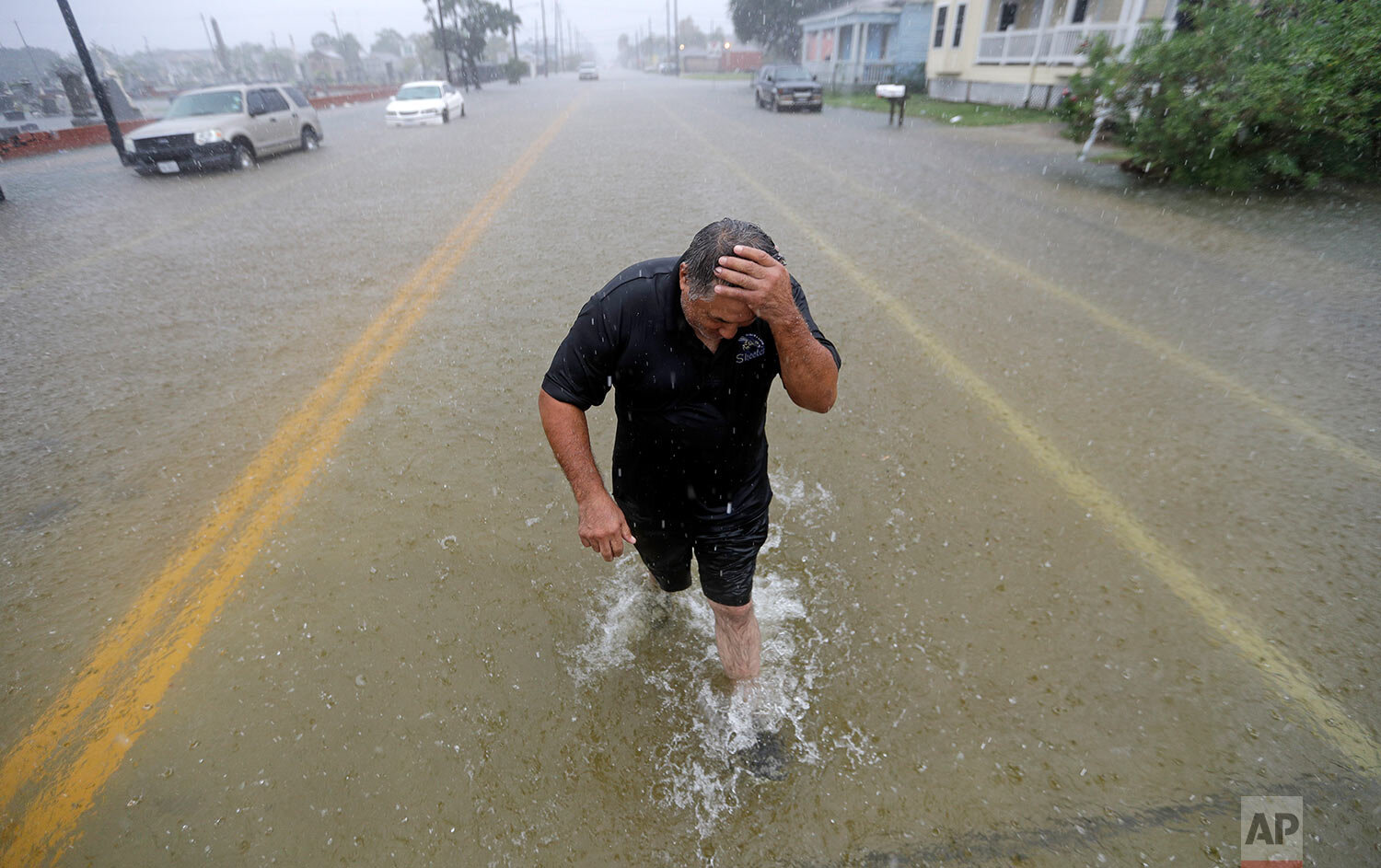  Angel Marshman wades through floodwaters from Tropical Depression Imelda after trying to start his flooded car Wednesday, Sept. 18, 2019, in Galveston, Texas. (AP Photo/David J. Phillip) 