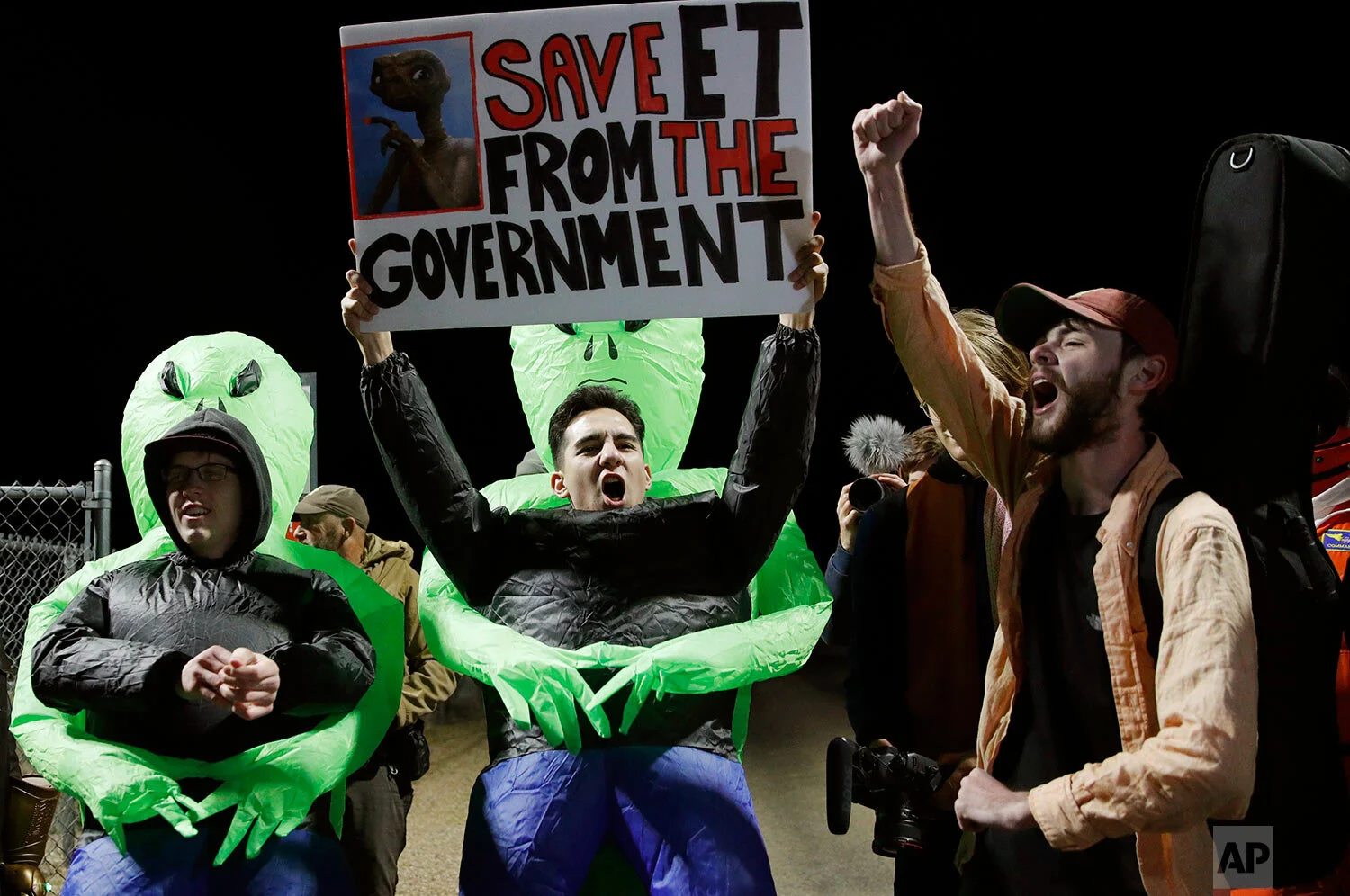 Mario Rayna, center, chants with others at an entrance to the Nevada Test and Training Range near Area 51 Friday, Sept. 20, 2019, near Rachel, Nev. (AP Photo/John Locher)