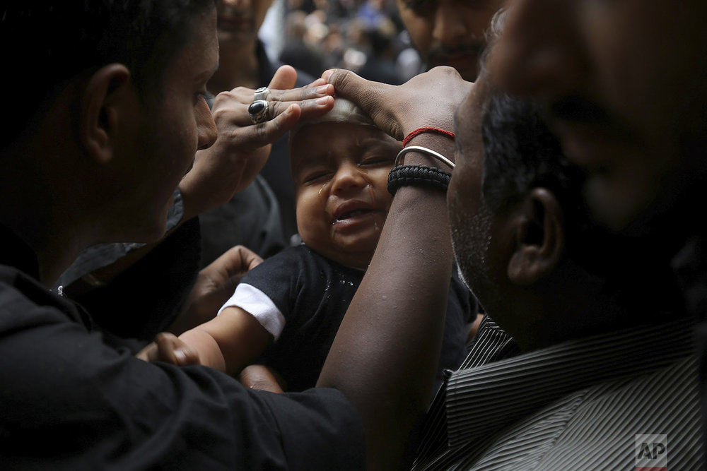  A Shiite Muslim child cries after he was given a cut on the forehead during an Ashoura procession in Hyderabad, India, Tuesday, Sept. 10, 2019. (AP Photo/Mahesh Kumar A.) 