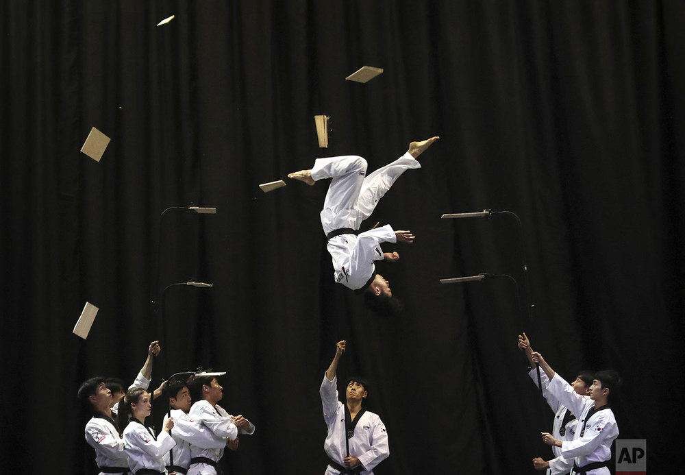  Members of the South Korean Taekwondo demonstration team perform during a visit by Bulgarian Prime Minister Boyko Borisov at Kukkiwon, the headquarters and academy of World Taekwondo, in Seoul, South Korea, Wednesday, Sept. 25, 2019. (AP Photo/Ahn Young-joon) 