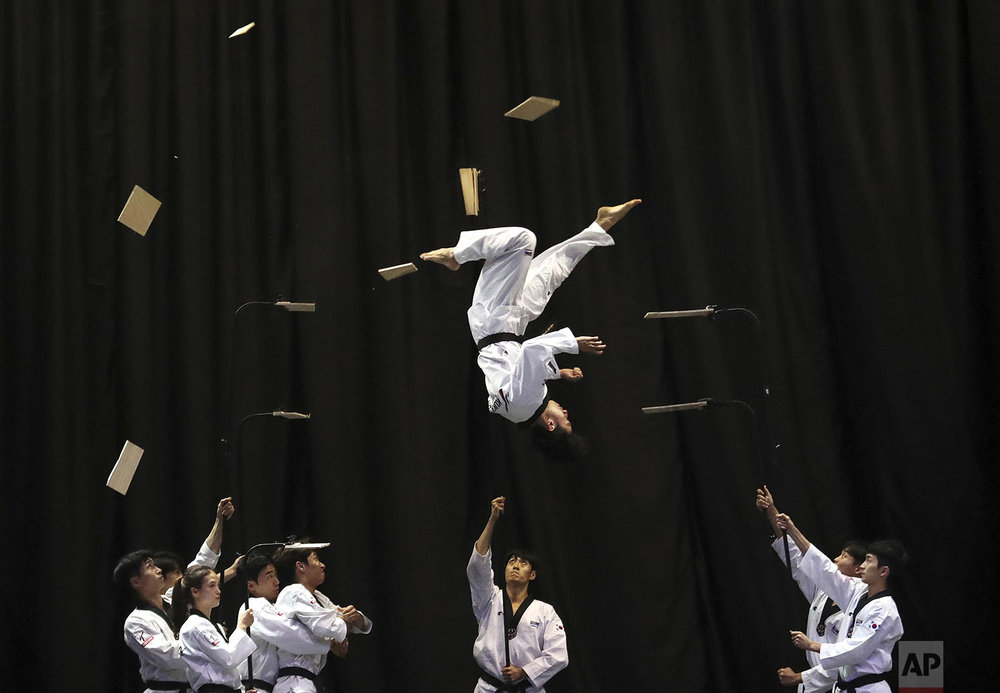 Members of the South Korean Taekwondo demonstration team perform during a visit by Bulgarian Prime Minister Boyko Borisov at Kukkiwon, the headquarters and academy of World Taekwondo, in Seoul, South Korea, Wednesday, Sept. 25, 2019. (AP Photo/Ahn Young-joon)