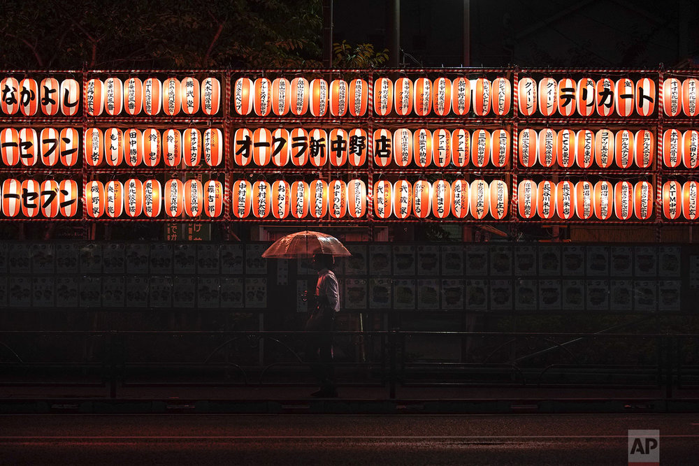  A man walks with an umbrella past lanterns in the Nakano district of Tokyo, Wednesday, Sept. 11, 2019. (AP Photo/Jae C. Hong) 