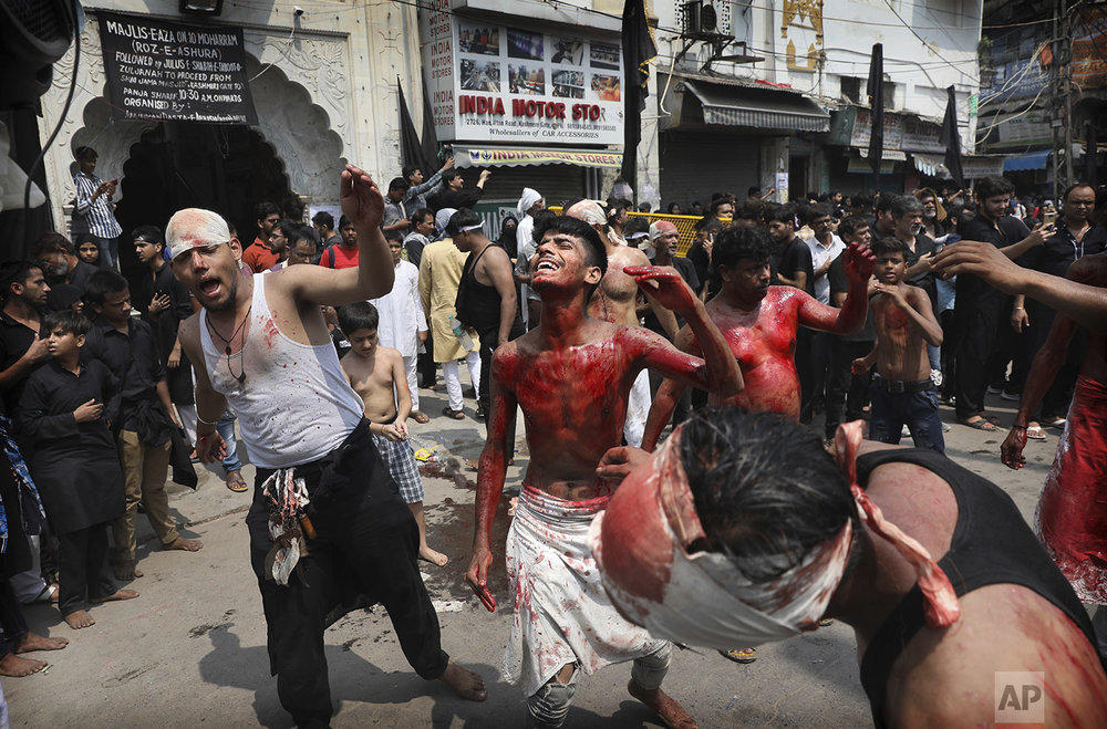Indian Shiite Muslims flagellate themselves with chained knives during an Ashoura procession in New Delhi, India, Tuesday, Sept. 10, 2019. (AP Photo/Manish Swarup)