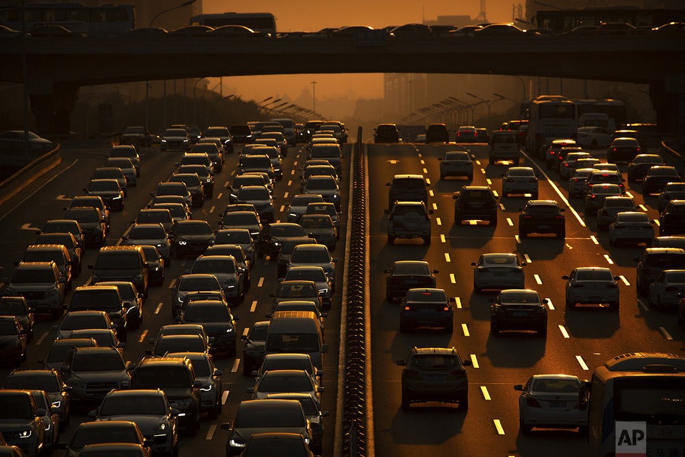 Commuters make their way along an expressway during rush hour in Beijing, Friday, Sept. 6, 2019. (AP Photo/Mark Schiefelbein)