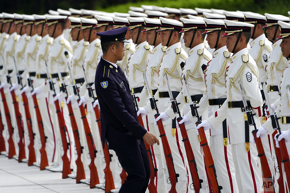  Japanese honor guard members prepare for an inspection by Prime Minister Shinzo Abe and Defense Minister Taro Kono ahead of the Japan Self-Defense Forces senior officers' gathering at Defense Ministry in Tokyo. (AP Photo/Eugene Hoshiko) 