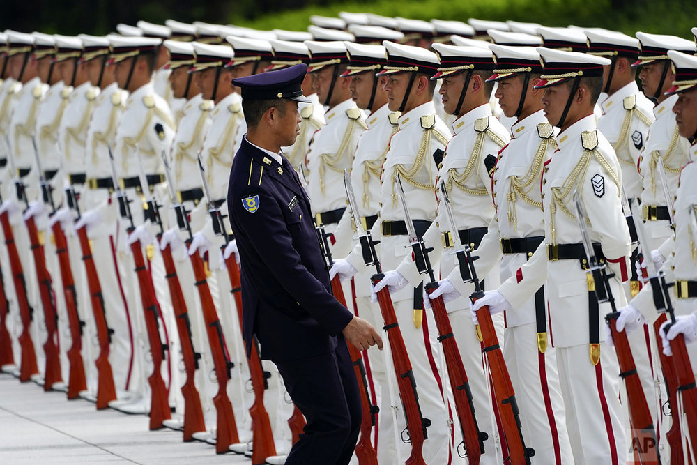 Japanese honor guard members prepare for an inspection by Prime Minister Shinzo Abe and Defense Minister Taro Kono ahead of the Japan Self-Defense Forces senior officers' gathering at Defense Ministry in Tokyo. (AP Photo/Eugene Hoshiko)