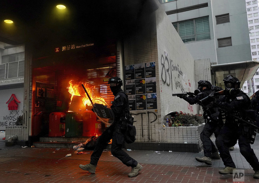 Riot police arrive after protestors vandalized an area in Hong Kong, Sunday, Sept. 29, 2019. (AP Photo/Vincent Yu)