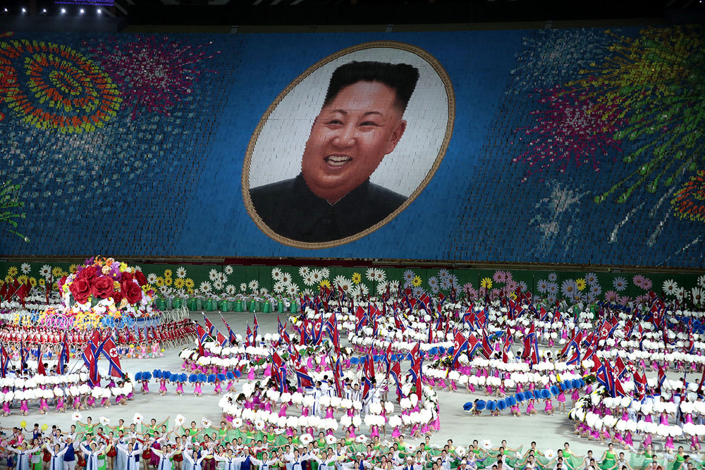 Performers hold up cards to form a portrait of North Korean leader Kim Jong Un during a mass games performance titled "The Land of the People" at May Day Stadium in Pyongyang, North Koreai, Wednesday, Sept. 11, 2019. (AP Photo/Dita Alangkara)