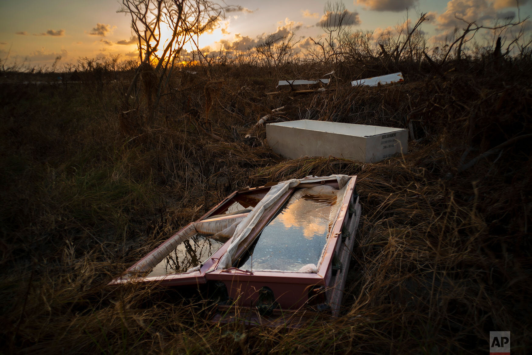  A shattered and water-filled coffin lays exposed to the elements in the aftermath of Hurricane Dorian, at the cemetery in Mclean's Town, Grand Bahama, Bahamas, Wednesday Sept. 11, 2019.  (AP Photo/Ramon Espinosa) 