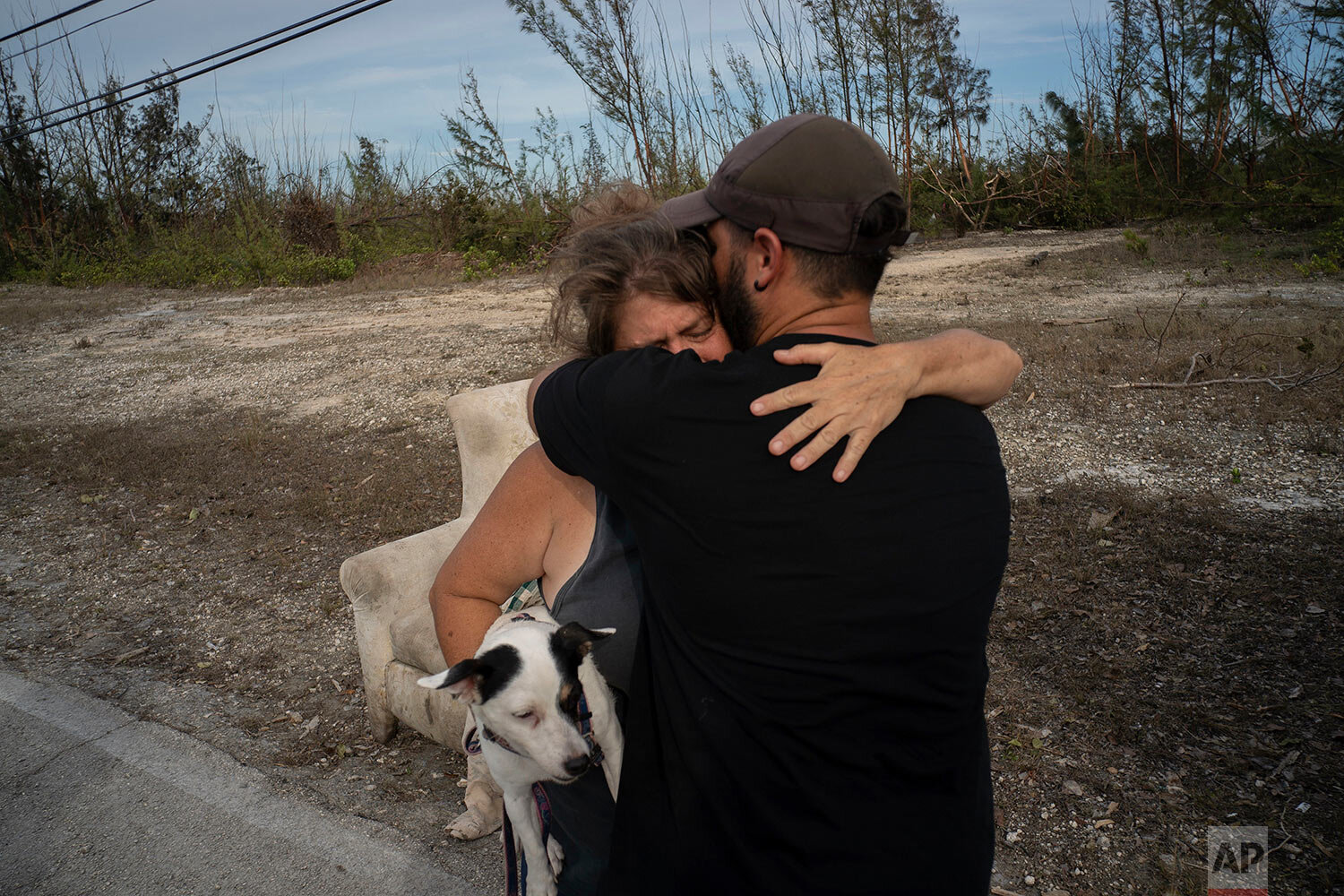  Sissel Mosvold embraces a volunteer who helped rescue her mother from her home, flooded by the waters of Hurricane Dorian, in the outskirts of Freeport, Bahamas, Wednesday, Sept. 4, 2019. (AP Photo/Ramon Espinosa) 