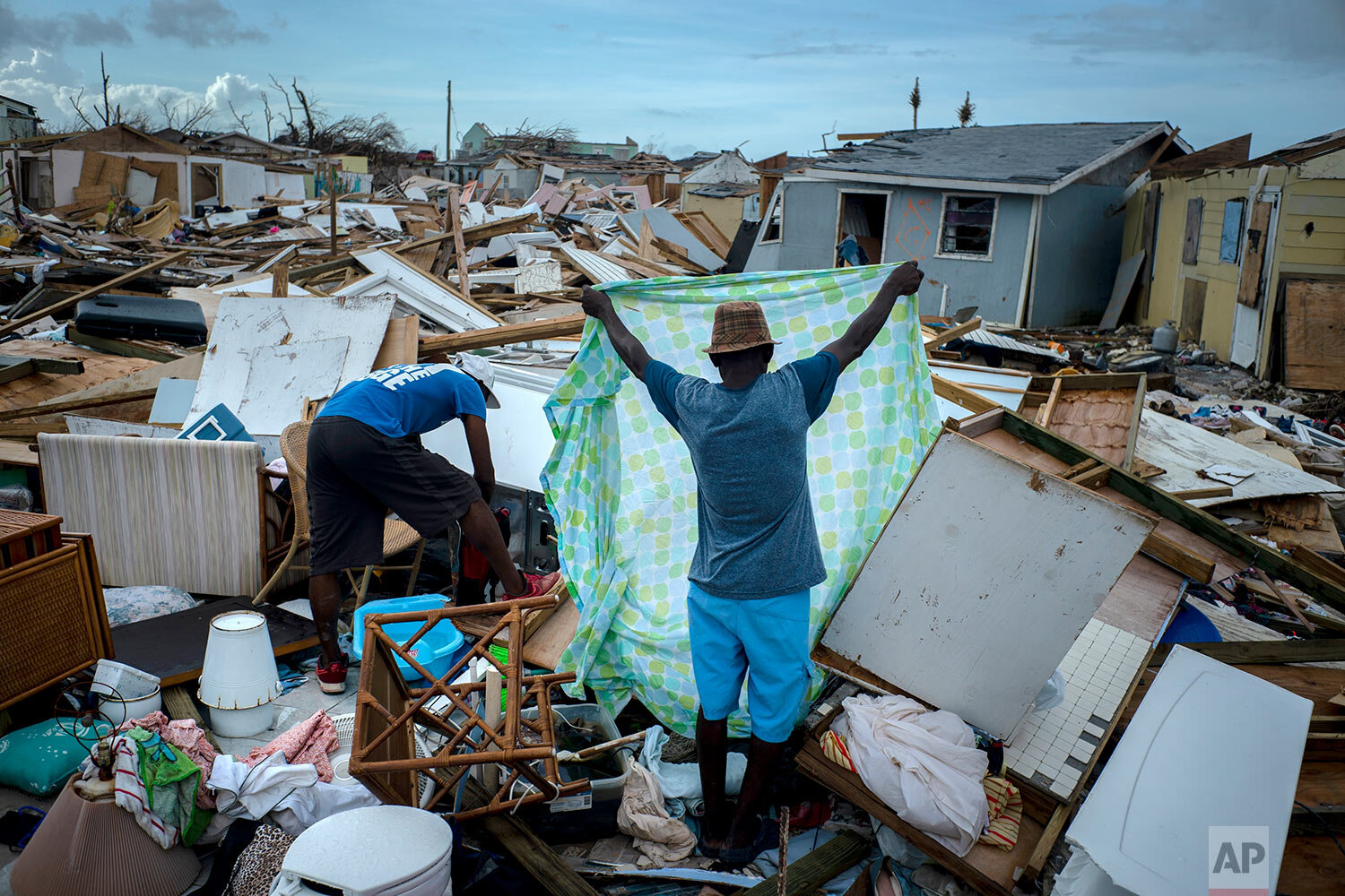  Immigrants from Haiti recover their belongings from the rubble in their destroyed homes, in the aftermath of Hurricane Dorian in Abaco, Bahamas, Monday, Sept. 16, 2019.  (AP Photo/Ramon Espinosa) 