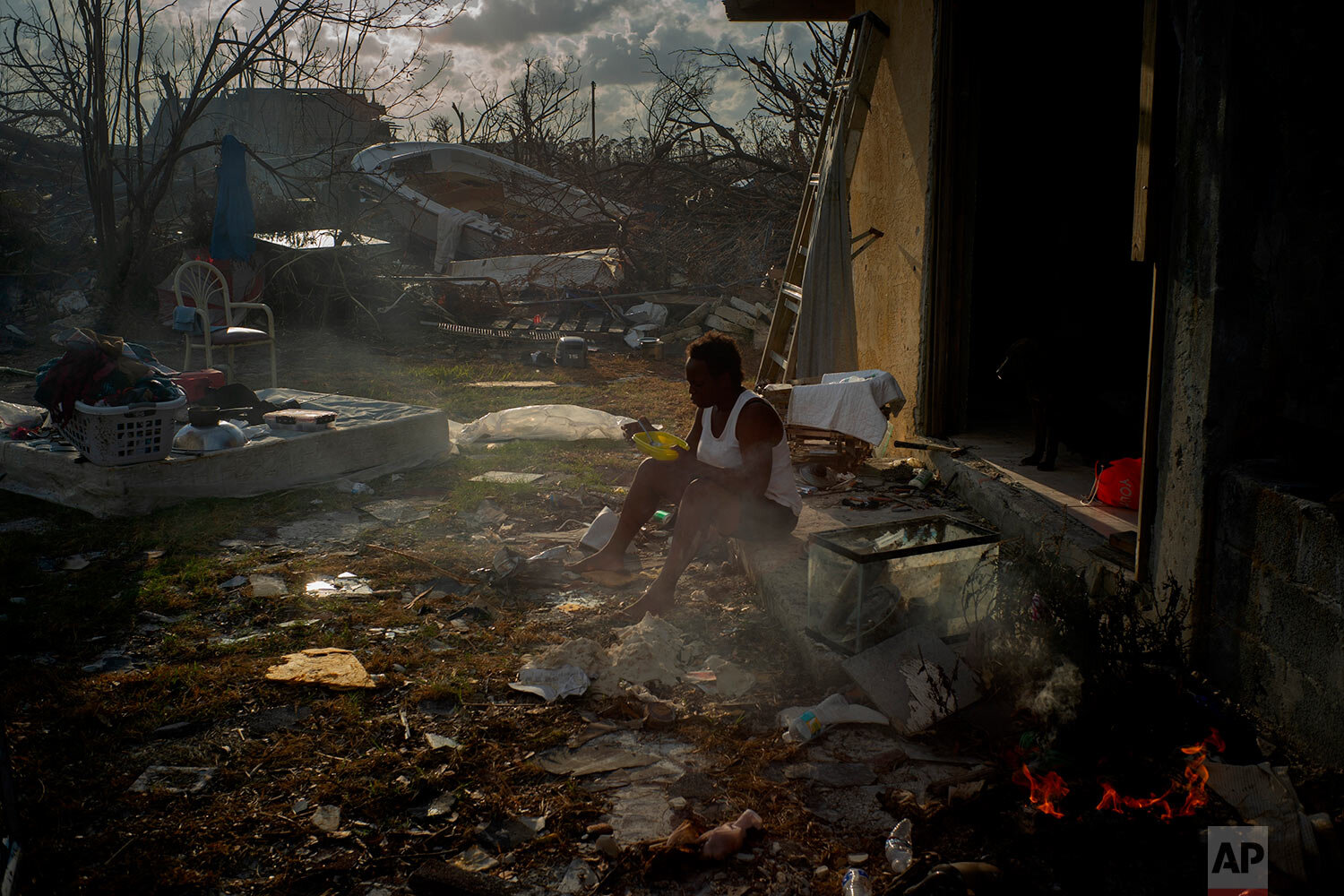  Tereha Davis, 45, eats a meal of rice as she sits among the remains of her shattered home, in the aftermath of Hurricane Dorian in McLean’s Town, Grand Bahama, Bahamas, Wednesday Sept. 11, 2019. She and others said they had not seen any government o