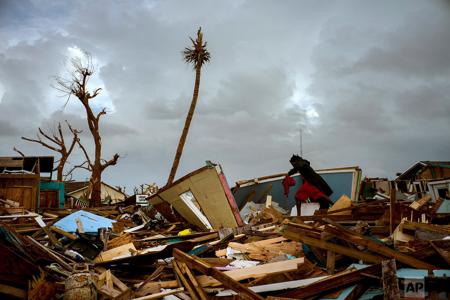  Vladimir Safford an immigrant from Haiti walks through the rubble next to his home in the aftermath of Hurricane Dorian in Abaco, Bahamas, Monday, Sept. 16, 2019. (AP Photo/Ramon Espinosa) 