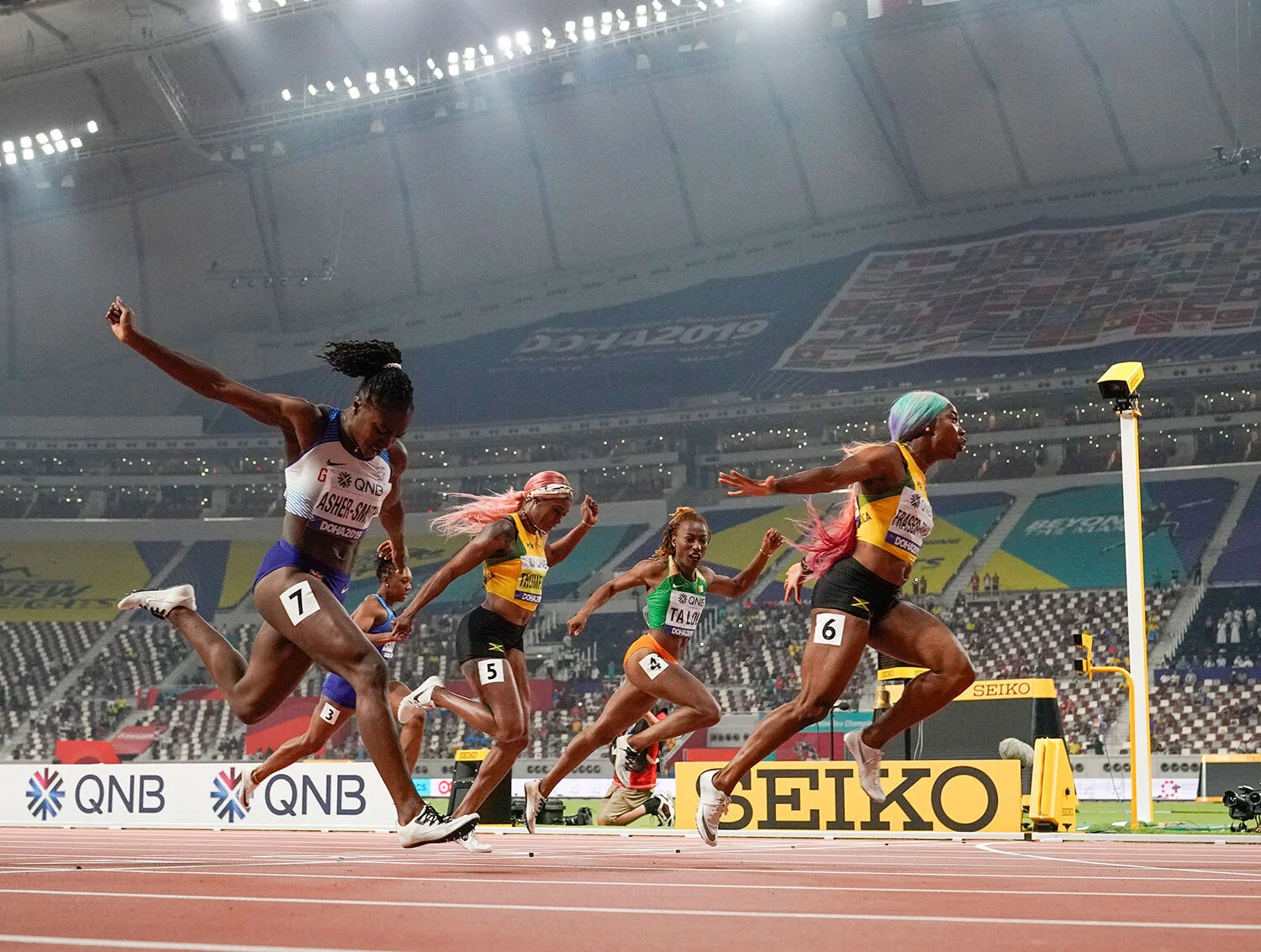 Shelly-Ann Fraser-Pryce (6), of Jamaica, finishes ahead of Dina Asher-Smith (7), of Great Britain, and Marie-Josée Ta Lou (4), of The Ivory Coast, in the women's 100-meter final at the World Athletics Championships in Doha, Qatar, Sunday, Sept. 29, 2019. (AP Photo/David J. Phillip)