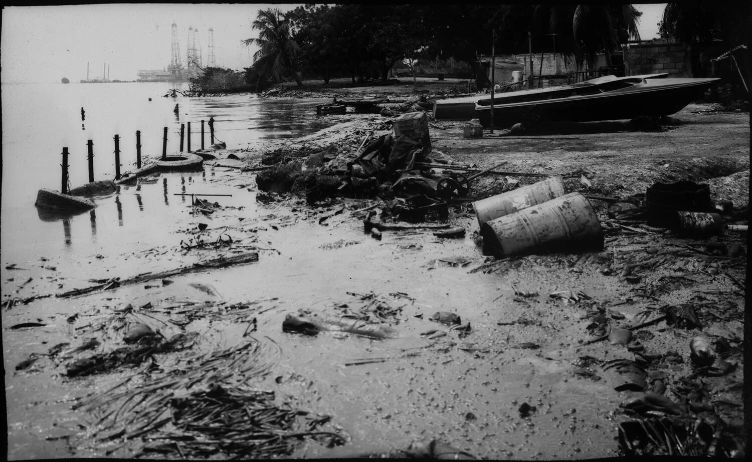 In this May 18, 2019 photo, objects on the shoreline covered with oil witness the destruction caused by the neglected and lack of maintenance of the state owned PDVSA in and around Lake Maracaibo, Cabimas, Venezuela. (AP Photo/Rodrigo Abd)