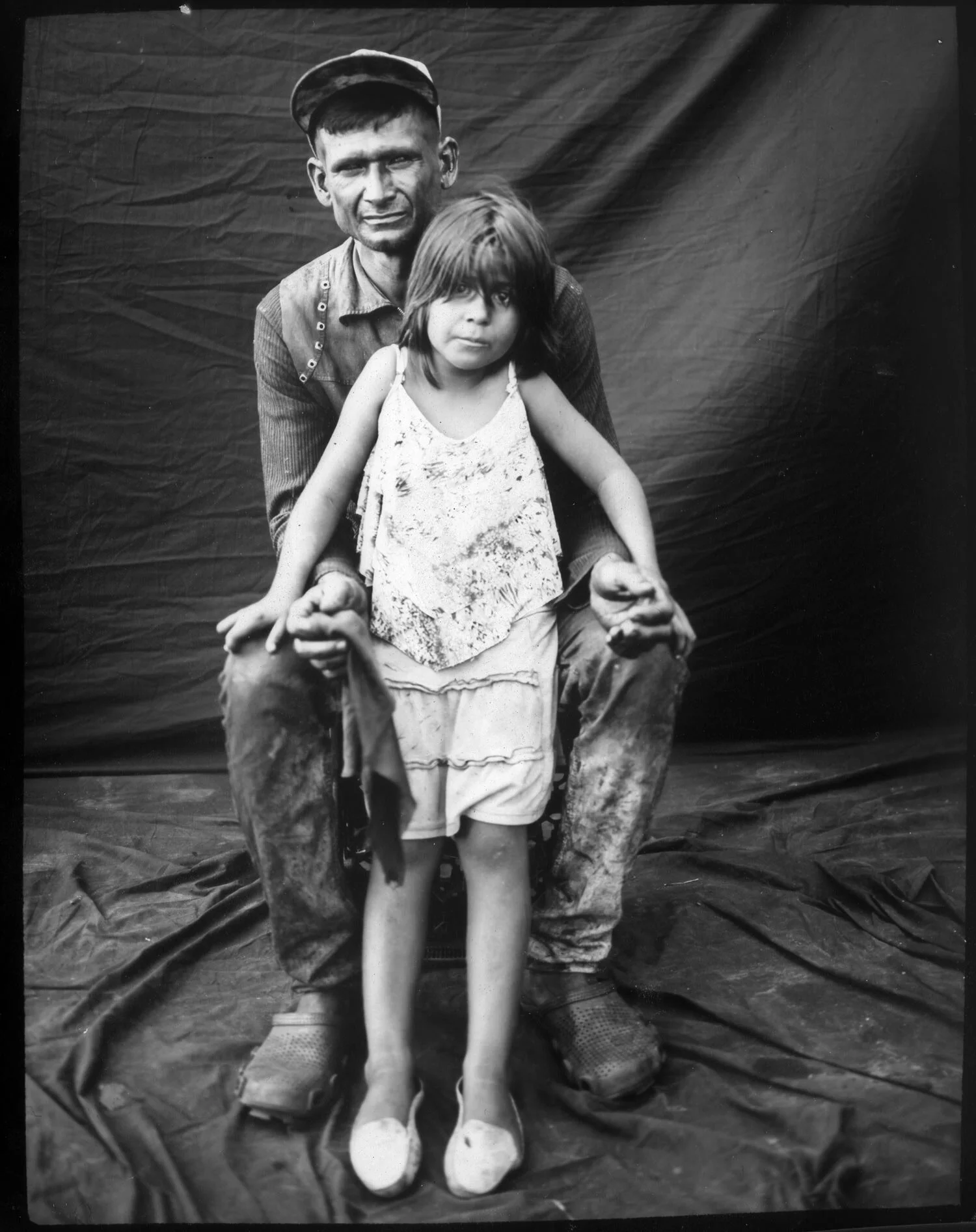 In this July 10, 2019 photo, fisherman Emanuel Salcedo, 34 poses for the picture with her daughter Emilialsen Salcedo, 7, after a journey fishing crabs on Lake Maracaibo at Cabimas, Venezuela. (AP Photo/Rodrigo Abd)