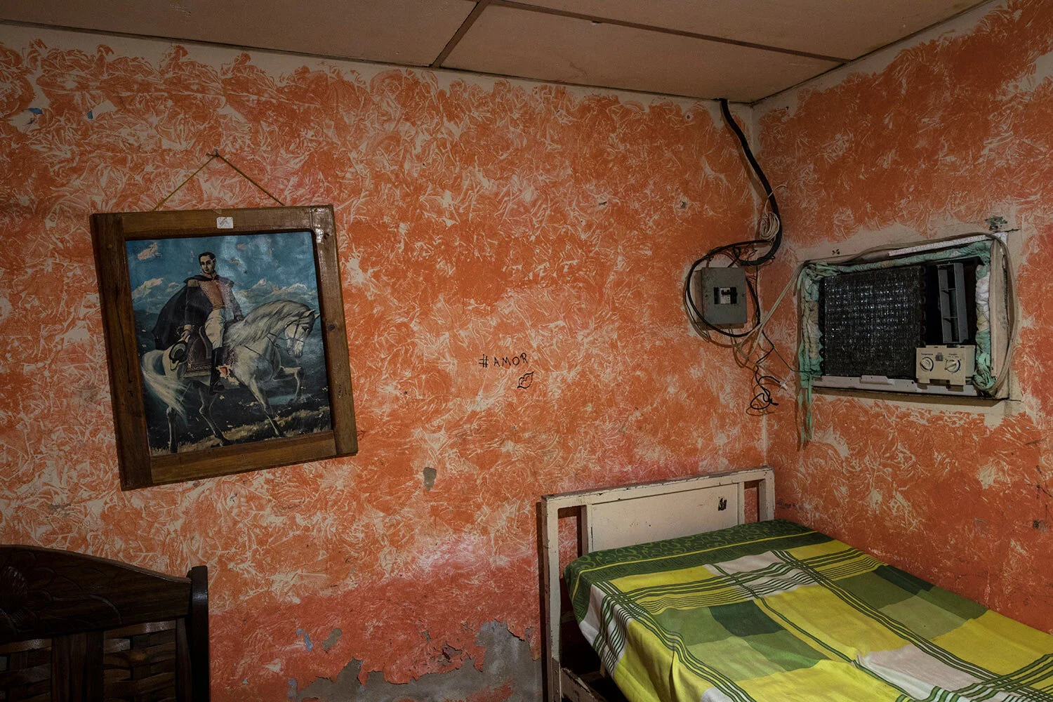 A painting of Venezuelan national hero Simon Bolivar hangs on the wall of a bedroom inside the home of the Rodriguez family, who fish for a living, in Cabimas, near Lake Maracaibo, Venezuela, July 11, 2019. (AP Photo/Rodrigo Abd)