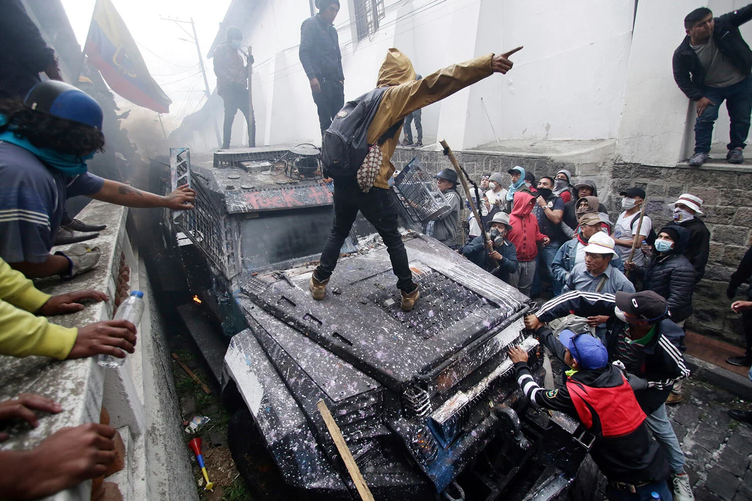Anti-government demonstrators commandeer an armored vehicle during a nationwide strike against President Lenin Moreno and his economic policies, in Quito, Ecuador, Wednesday, Oct. 9, 2019. Big jumps in the costs of gasoline and diesel after Moreno ended subsidies last week set off the upheaval, but other complaints have come out amid the protests, looting, vandalism, clashes with security forces, the blocking of highways and disruptions of Ecuador's vital oil industry. (AP Photo/Carlos Noriega)