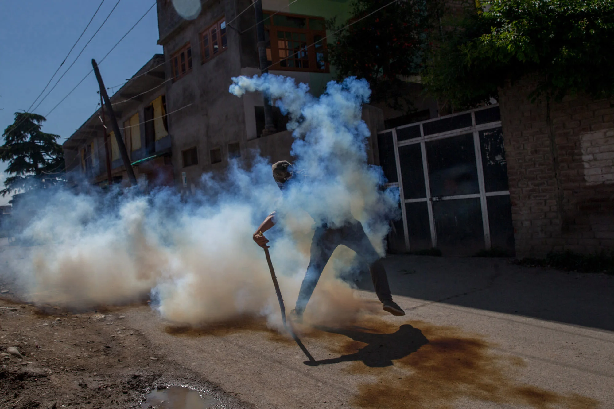 A Kashmiri protester throws exploded tear gas shell back at Indian policemen during a protest in Srinagar, Indian controlled Kashmir, June 9, 2017. (AP Photo/Dar Yasin)