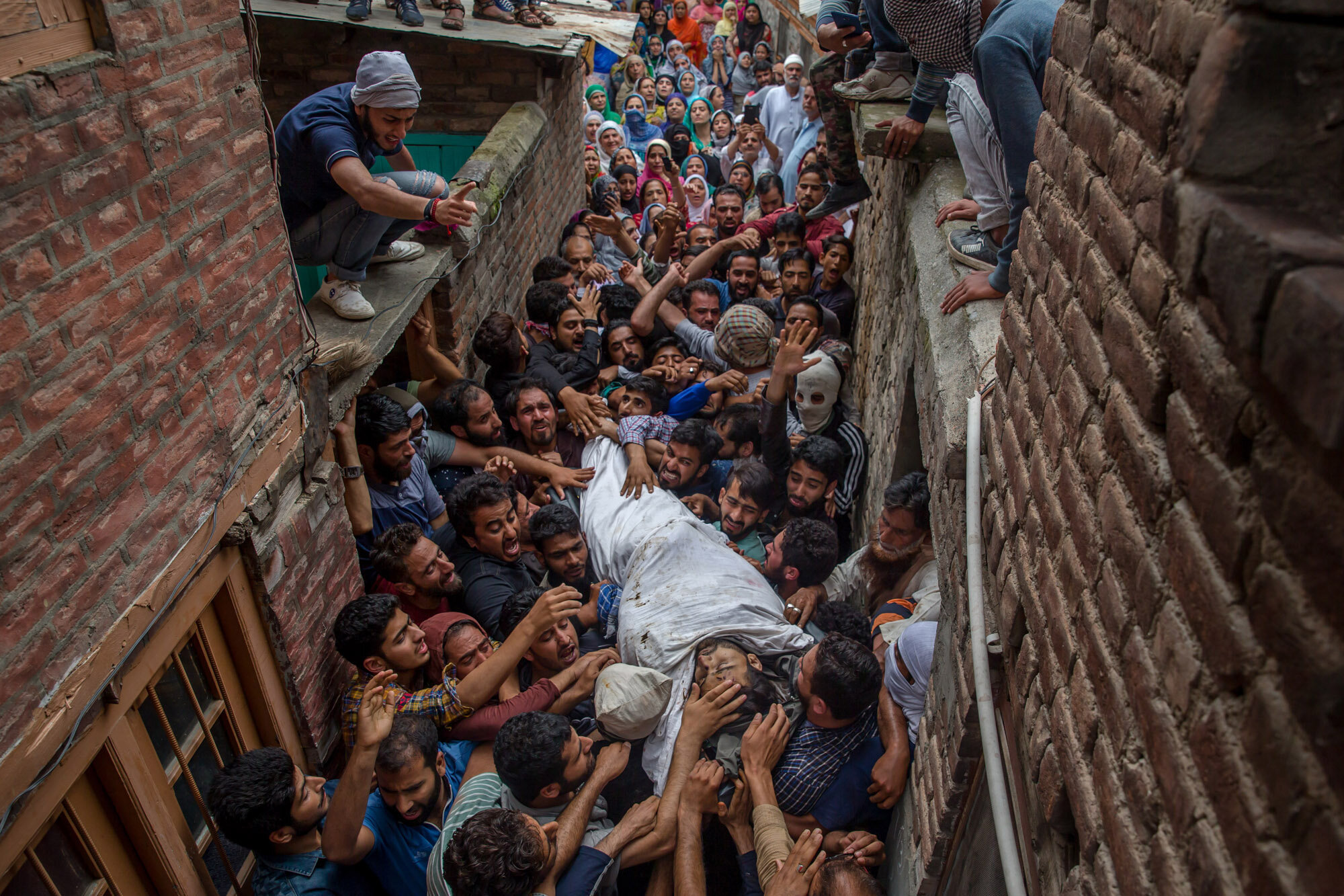 ...pro-freedom slogans as they carry body of a local rebel Sajad Ahmed Gilk...