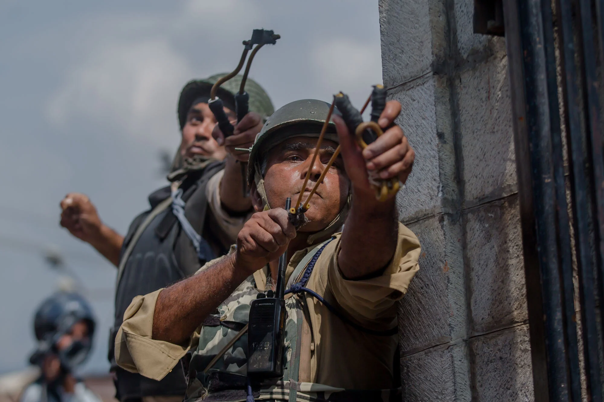 Indian paramilitary soldiers uses slings to shoot glass marbles at Kashmiri protesters in Srinagar, Indian controlled Kashmir, Aug. 4, 2017. (AP Photo/Dar Yasin)