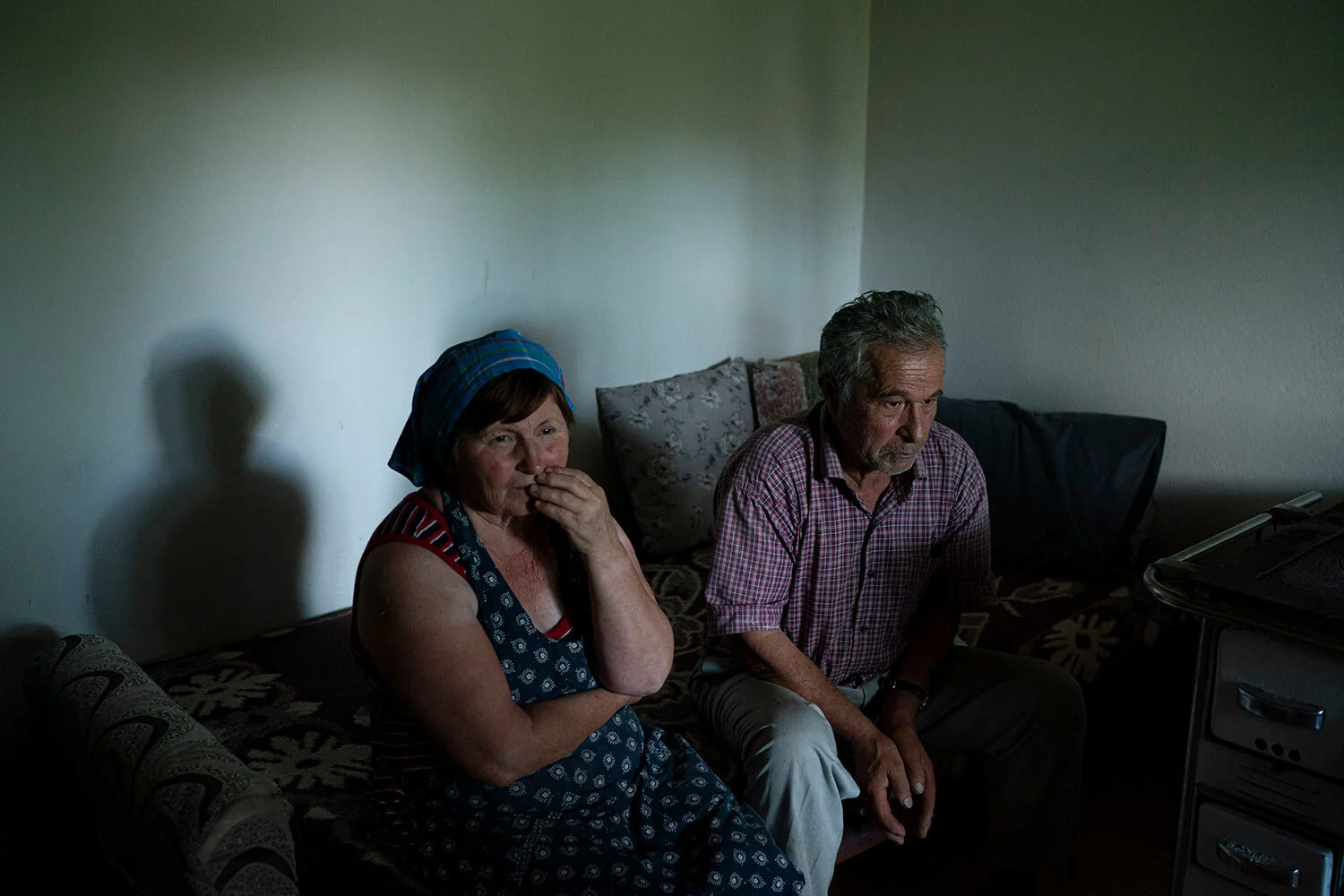 Jorgji Ilia, 71, a retired schoolteacher, sits with his wife, Vito, 64, inside their home in the village of Kanikol, Albania. (AP Photo/Felipe Dana)