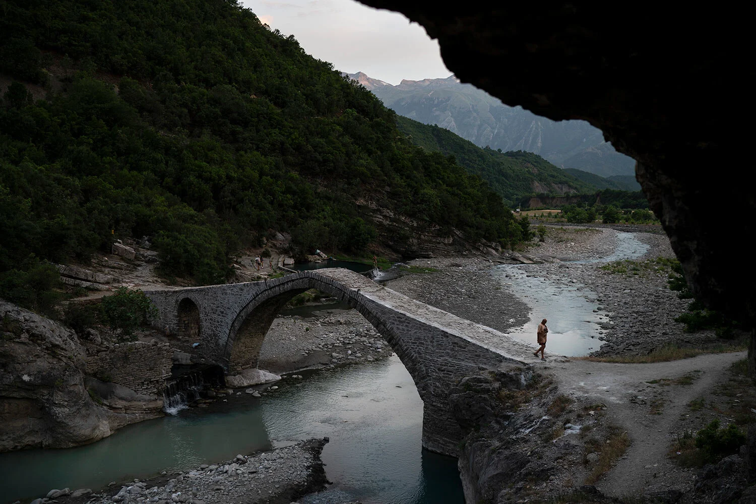 A man crosses a bridge over the Langarica River, a tributary to the Vjosa near the city of Permet, Albania. (AP Photo/Felipe Dana)