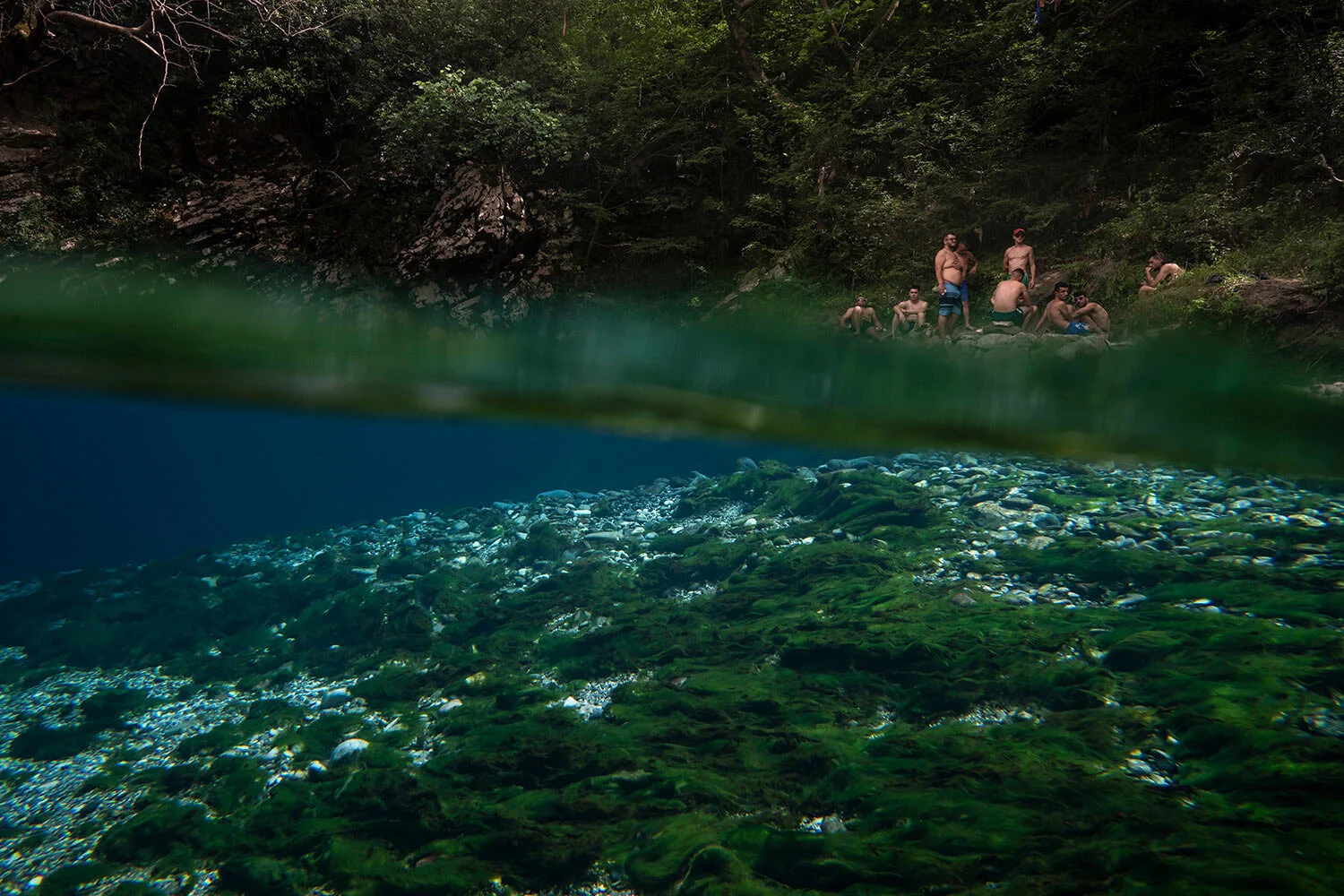 Residents sit on the shore of the Vjosa River next to a spring in the Kelcyre Gorge, Albania. (AP Photo/Felipe Dana)