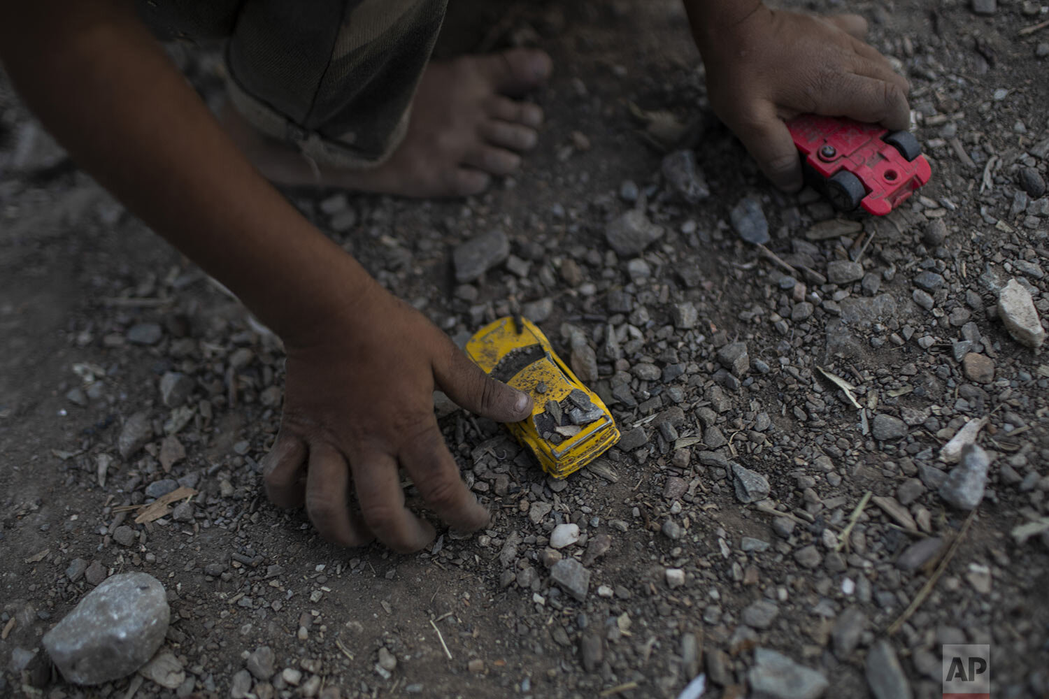 A Syrian boy plays with a toy car at the Moria refugee and migrant camp on the Greek island of Lesbos, Thursday, Oct. 3, 2019. (AP Photo/Petros Giannakouris)