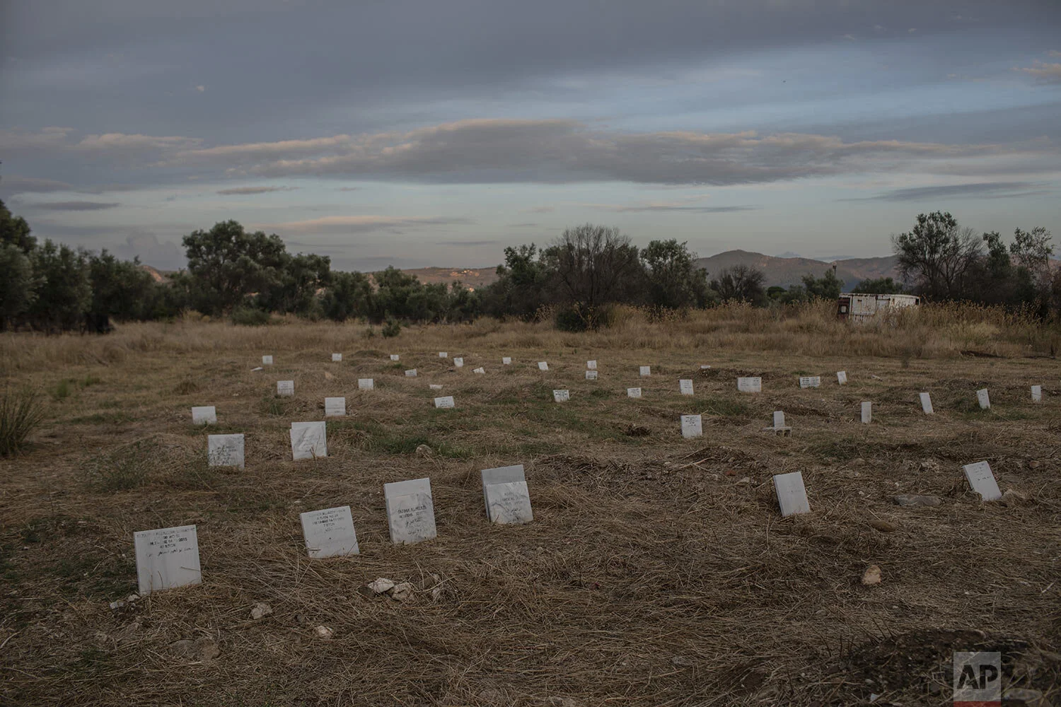 Tombstones marking the graves of migrants and refugees who drowned at sea while crossing from nearby Turkey are seen at a cemetery near the village of Kato Tritos on the northeastern Aegean island of Lesbos, Greece, Saturday Oct. 5, 2019. (AP Photo/Petros Giannakouris)