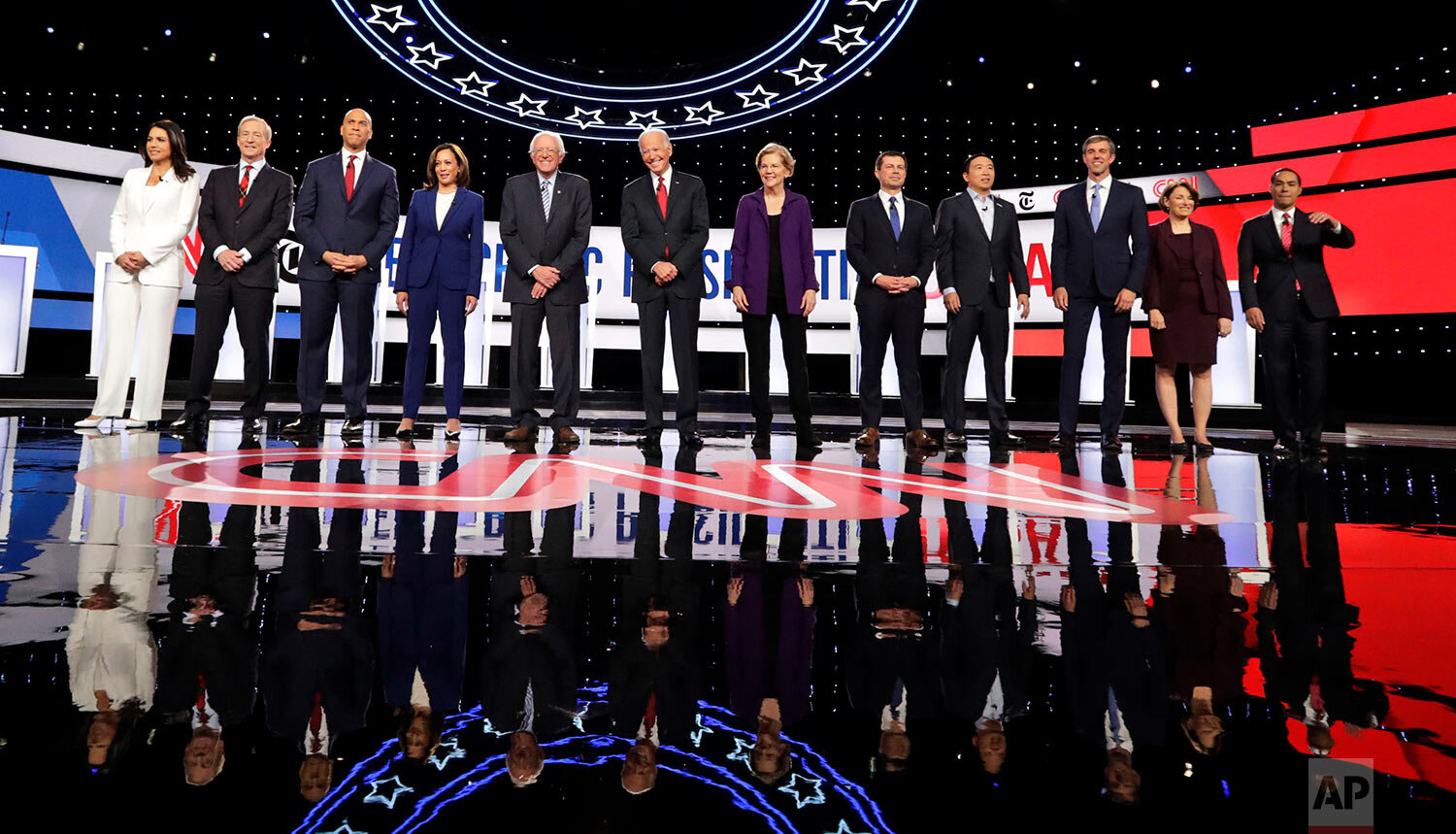  From left, Democratic presidential candidates, Rep. Tulsi Gabbard, D-Hawaii, businessman Tom Steyer, Sen. Cory Booker, D-N.J., Sen. Kamala Harris, D-Calif., Sen. Bernie Sanders, I-Vt., former Vice President Joe Biden, Sen. Elizabeth Warren, D-Mass.,