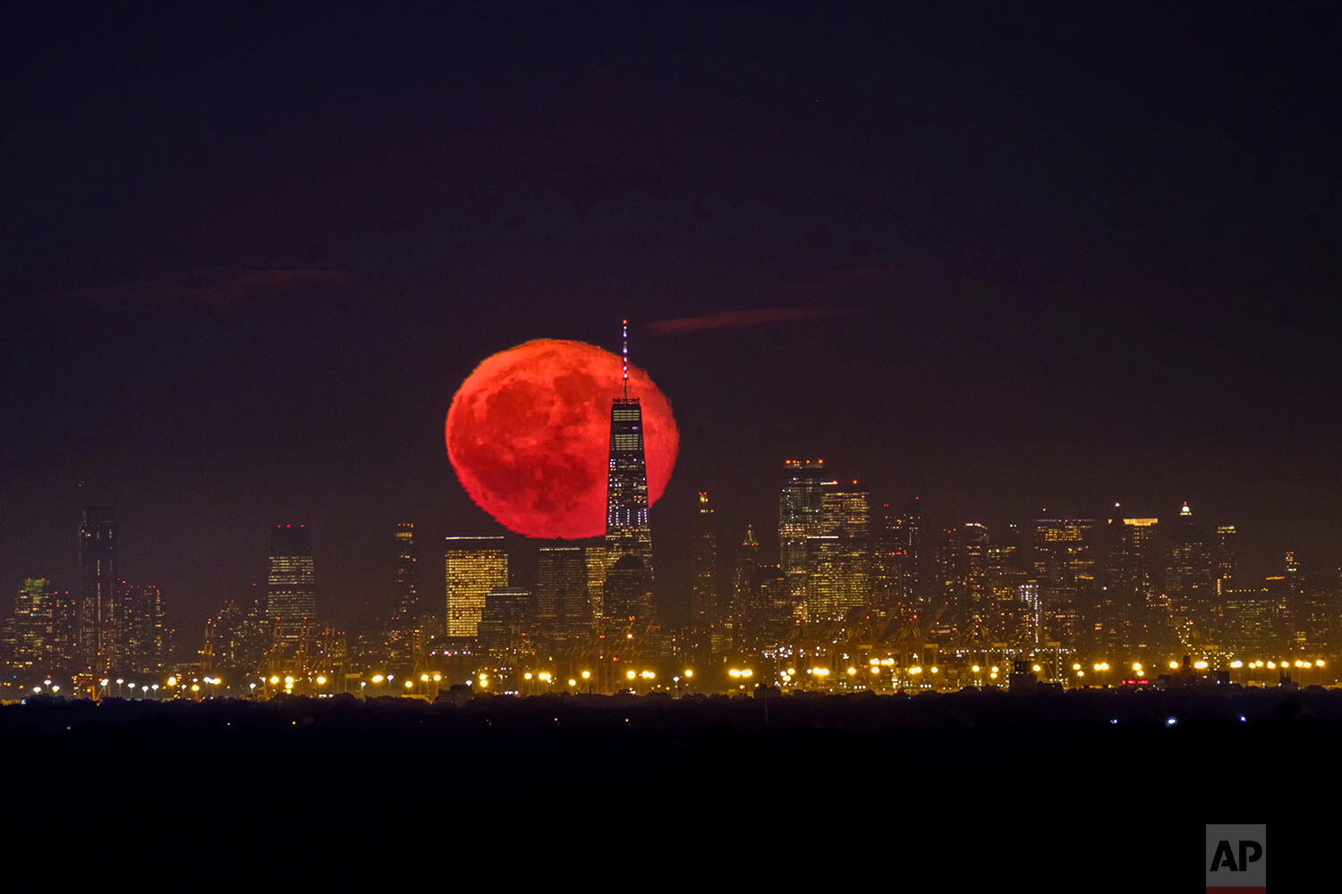 The moon rises behind One World Trade Center on a clear night in Lower Manhattan neighborhood of New York, as seen from Green Brook Township, N.J., Tuesday, Oct. 15, 2019. (AP Photo/J. David Ake)