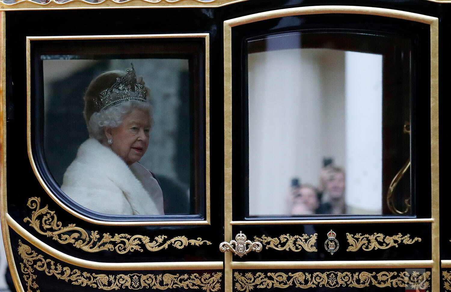  Britain's Queen Elizabeth II travels in a carriage to parliament for the official State Opening of Parliament in London, Monday, Oct. 14, 2019. (AP Photo/Frank Augstein) 