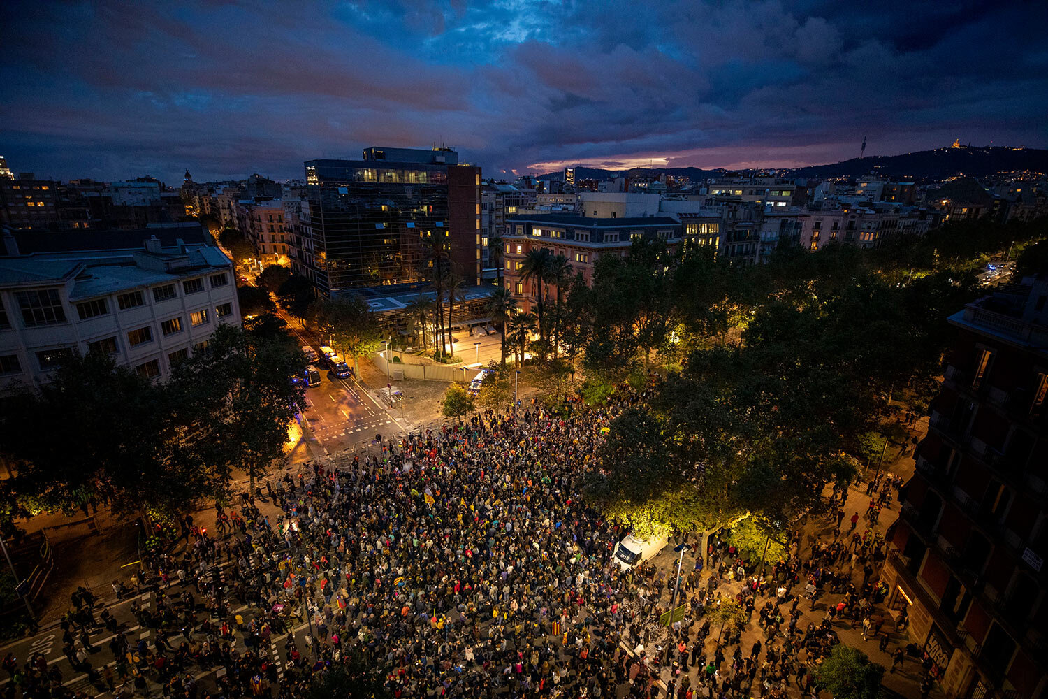 Pro-independence demonstrators gather next to the department of Interior in Catalonia, during a demonstration in Barcelona, Spain, Monday, Oct. 21, 2019. Protesters are angered by a Supreme Court verdict that sentenced nine separatist leaders to prison. (AP Photo/Emilio Morenatti)