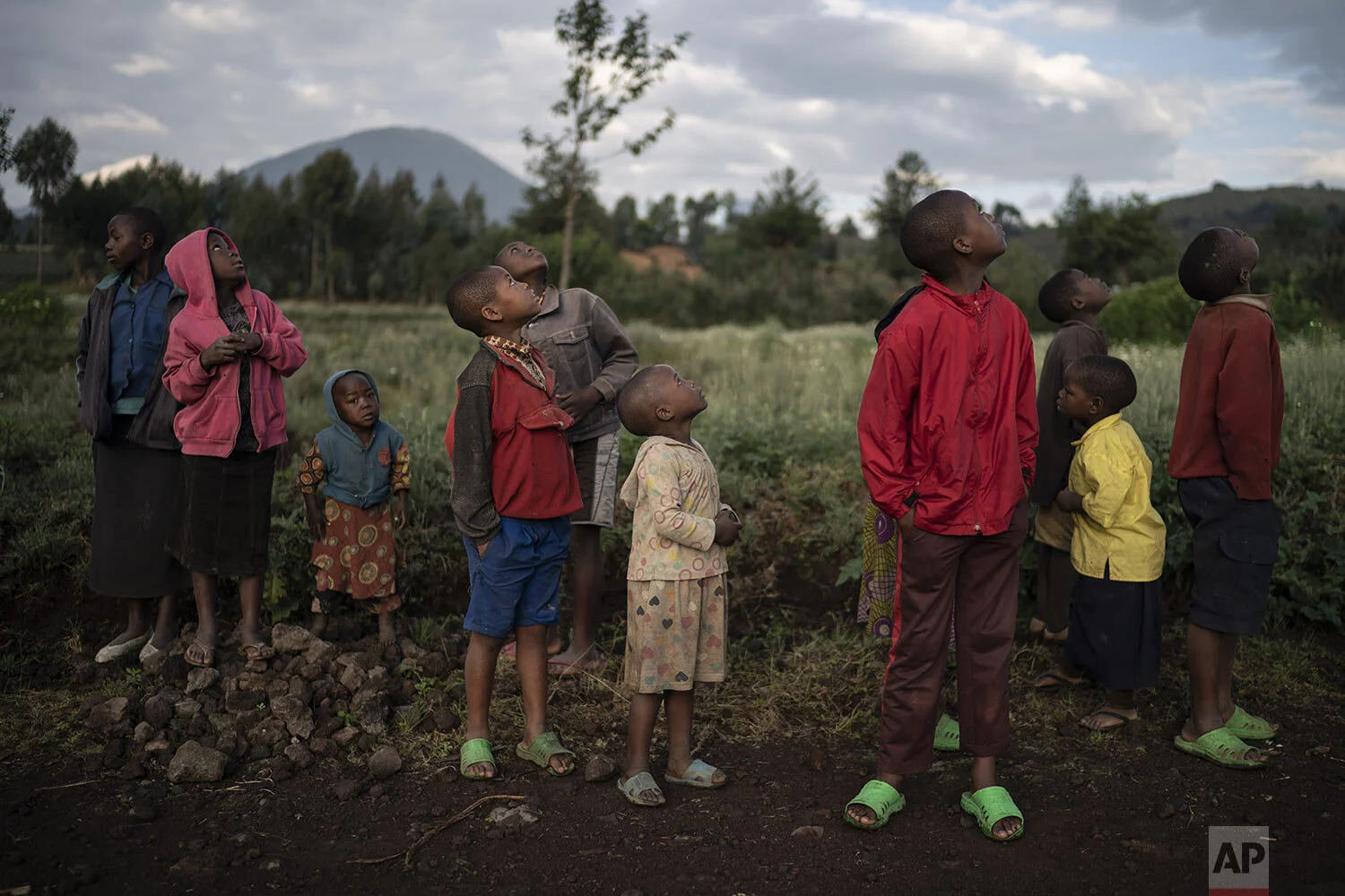 Children watch a drone flying near the Volcanoes National Park in Kinigi, Rwanda. (AP Photo/Felipe Dana)