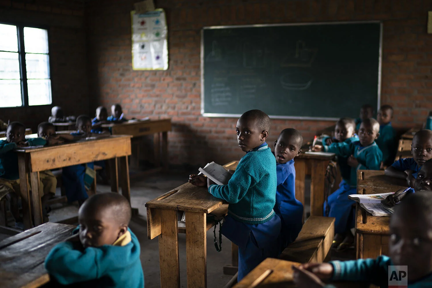 Children attend class at the Nyabitsinde Primary School near the Volcanoes National Park in Kinigi, Rwanda. (AP Photo/Felipe Dana)