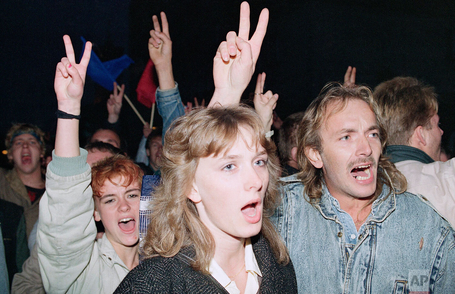  East German demonstrators flash victory signs as they demand democratic reforms in a massive protest in downtown East Berlin, Oct. 7, 1989. (AP Photo/Heribert Proepper) 