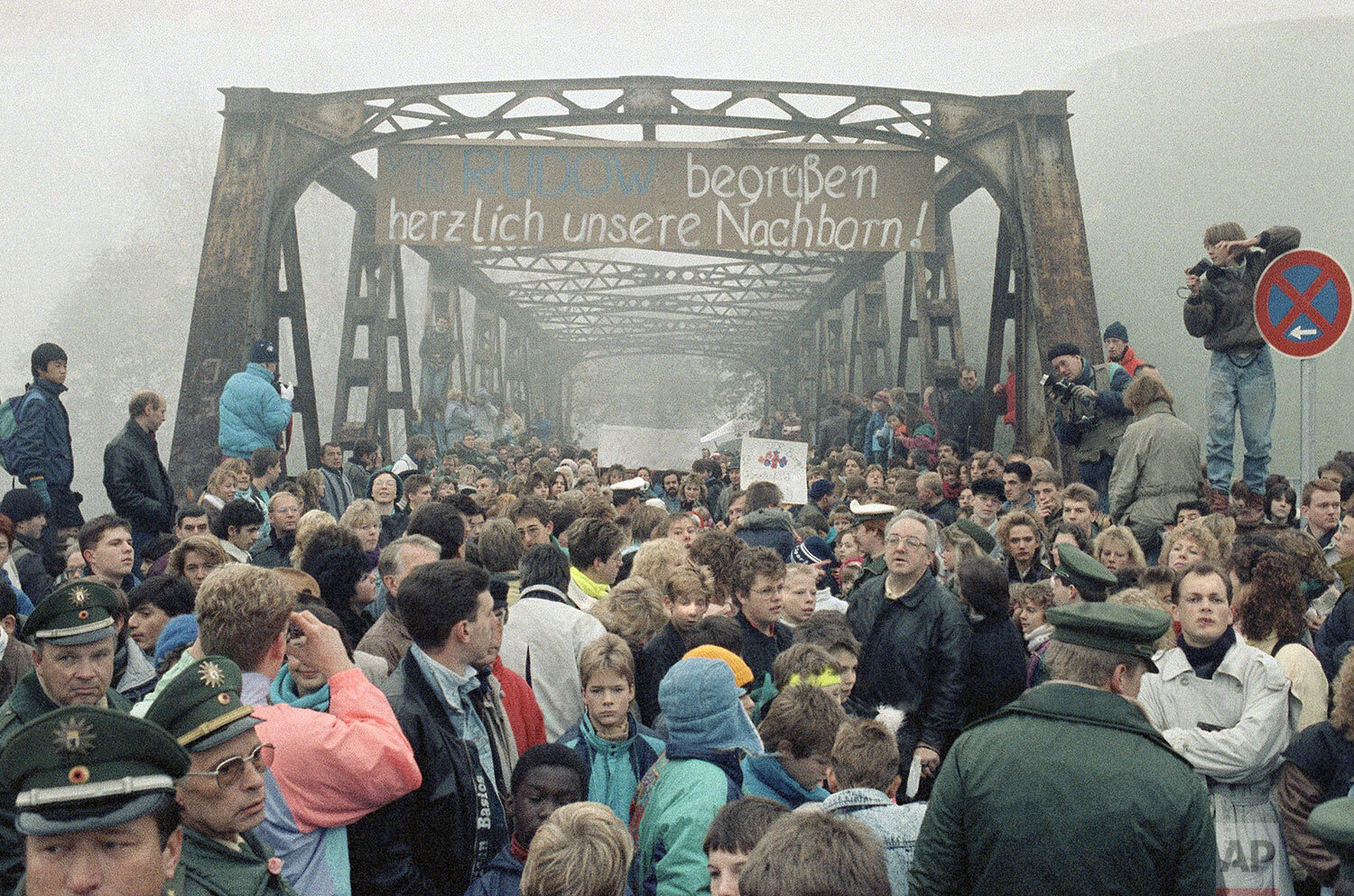  People crowding Masante Bridge at Stubenrauchstrasse in Berlin on Tuesday, Nov. 14, 1989, to celebrate opening of another border passage between East and West Berlin. In this image taken from West Berlin side of the wall, the banner reads: "We are w