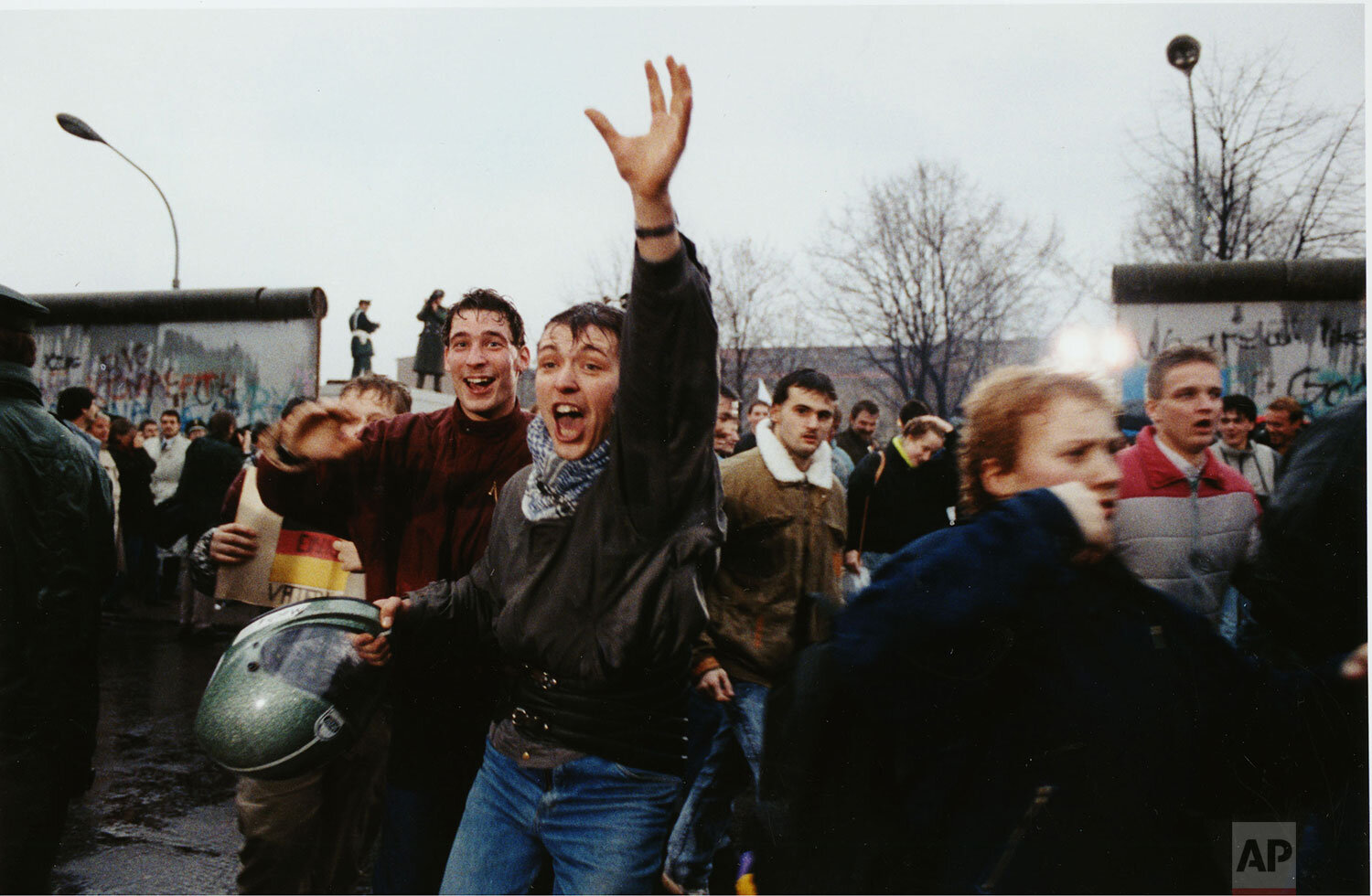  Young East Berliners shout for joy as they run into West Berlin through an opening in the Berlin Wall near the Brandenburg Gate, Fri., Dec. 23, 1989. (AP Photo/Hansjoerg Krauss) 