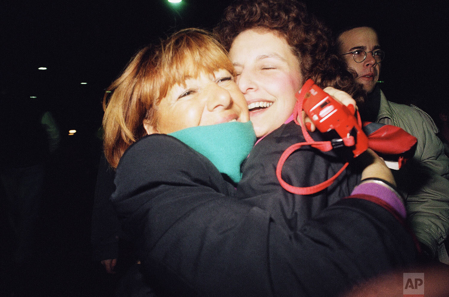  Two Berlin women hug each other at a border crossing point in West Berlin, Nov. 10, 1989 after the gates at the borders opened. (A Photo/Jockel Finck) 